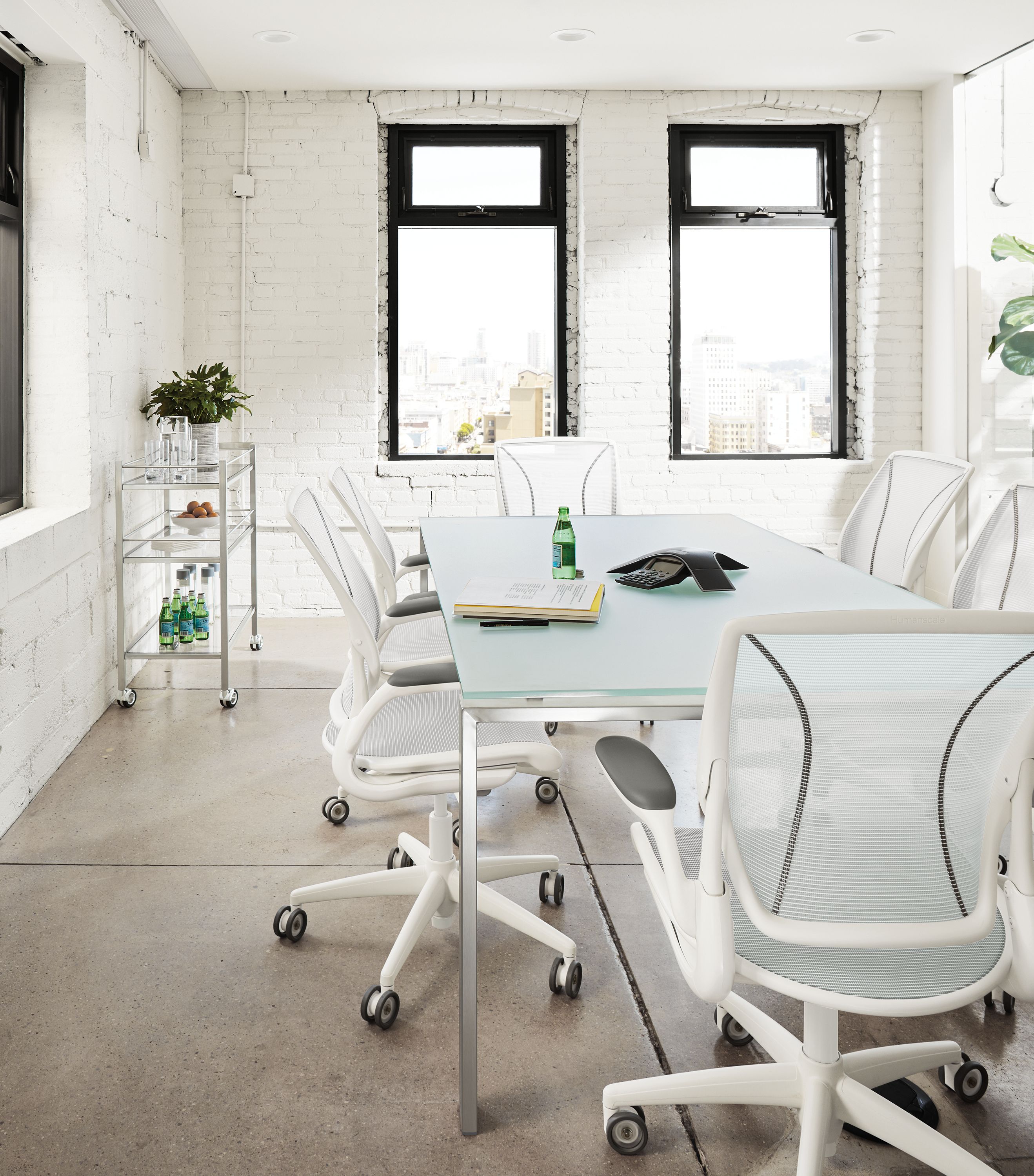Conference room with Rand 78-wide table in stainless steel and etched glass and 6 Diffrient chairs in white.