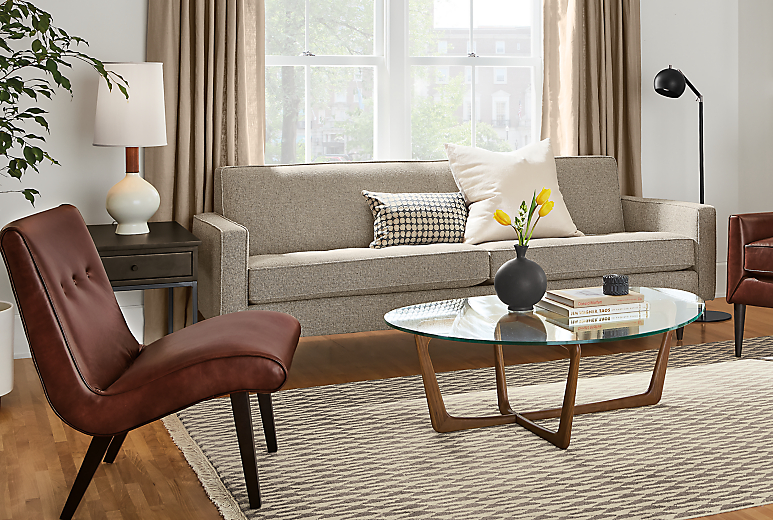 Living room setting with Reese 85-inch sofa an delia chair in Portofino Syrah. 