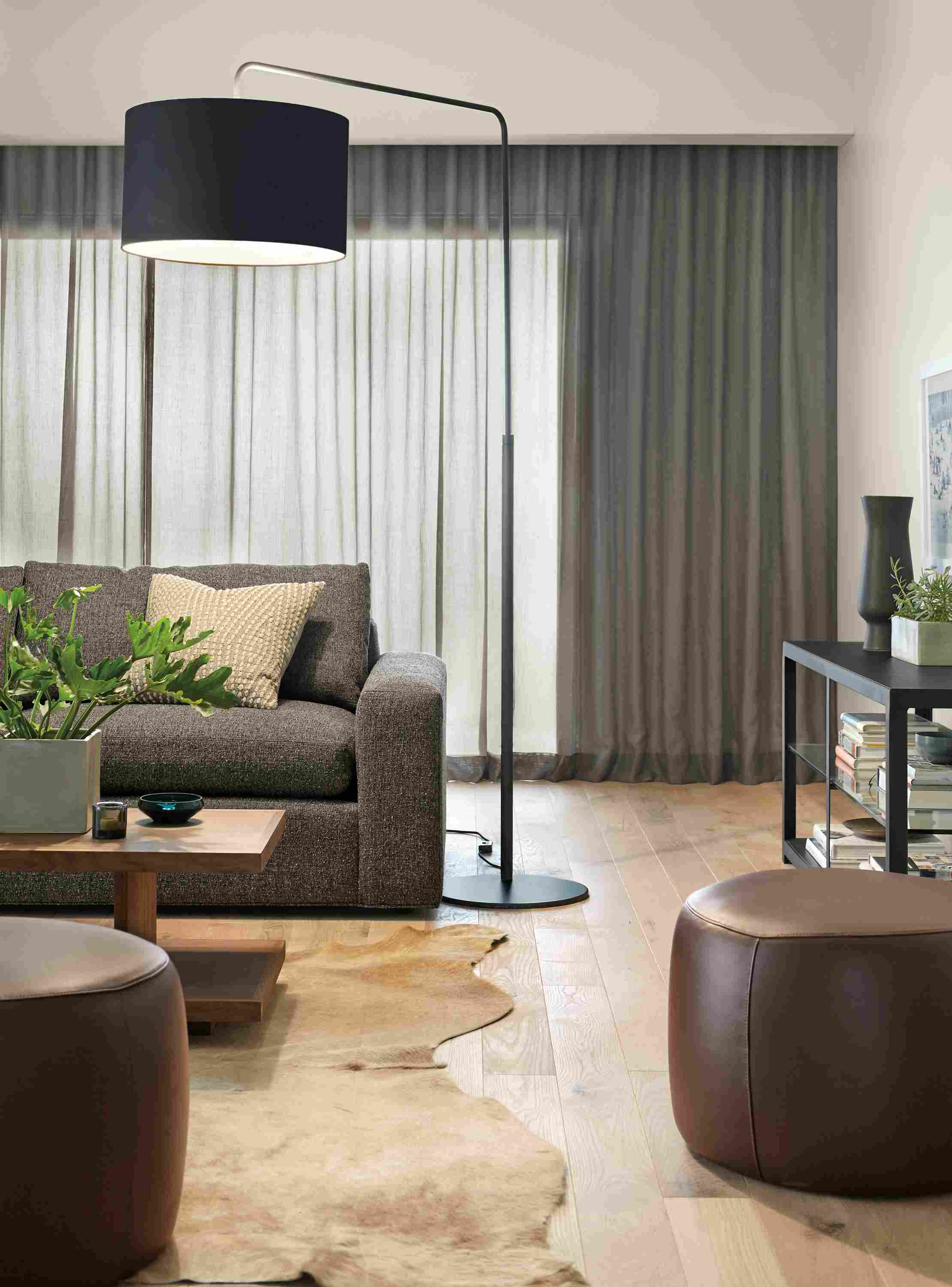 Living room with Rayne floor lamp in black and 2 Lind cocktail ottomans in cape dark brown leather.