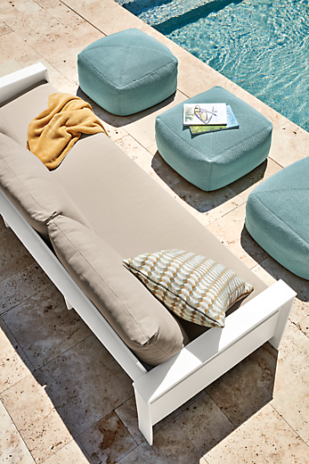 Rayo 92-inch outdoor sofa in White with Niro Beige cushions and three Zena outdoor poufs in spa.