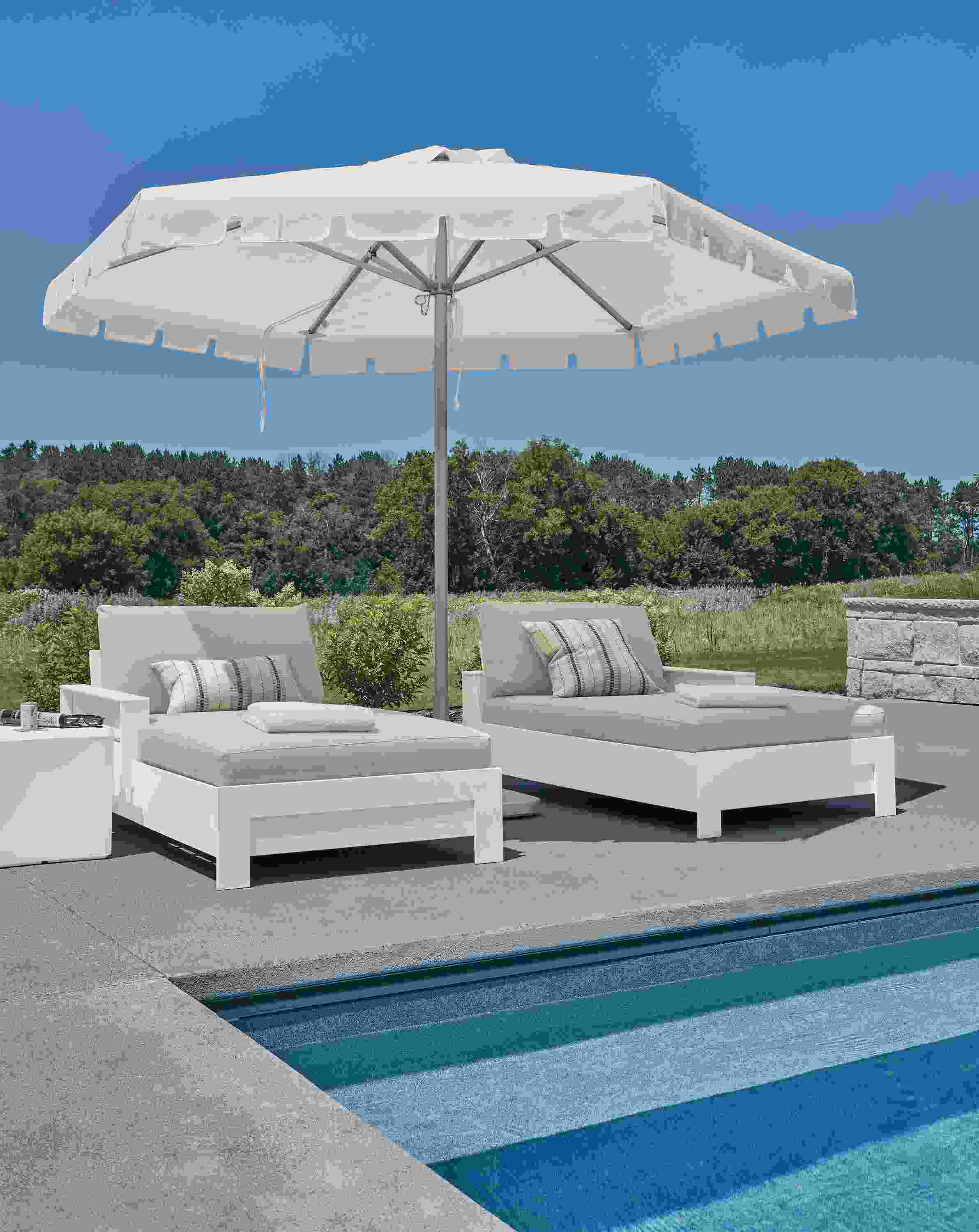Rayo left-arm and right arm chaises in Mist Grey and White HDPE and Pacifica Umbrella in Jace white/natural.