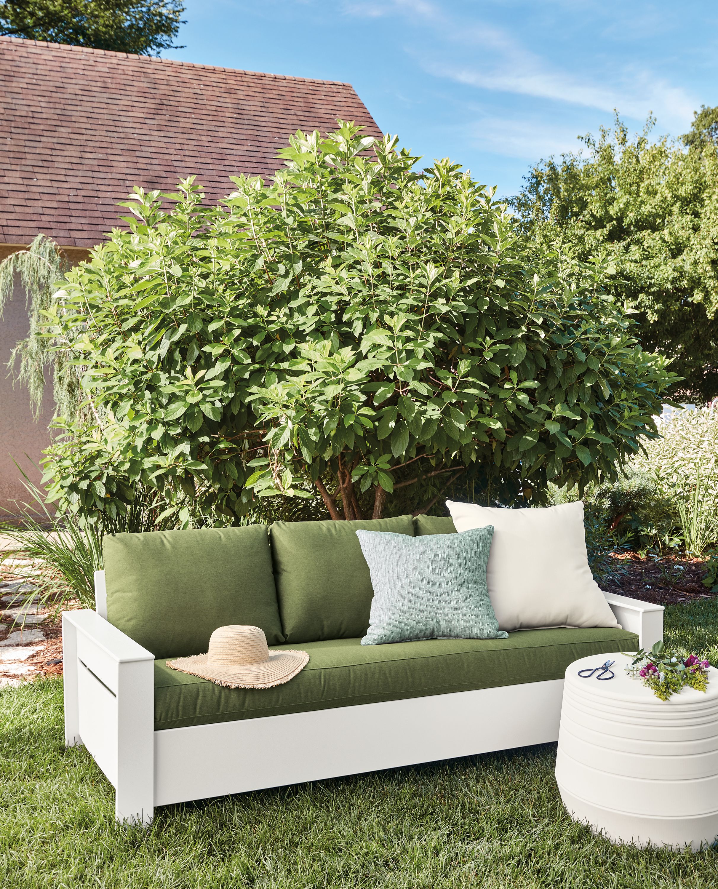Outdoor setting with Rayo 75-inch sofa in White with Sunbrella Canvas Fern cushions.