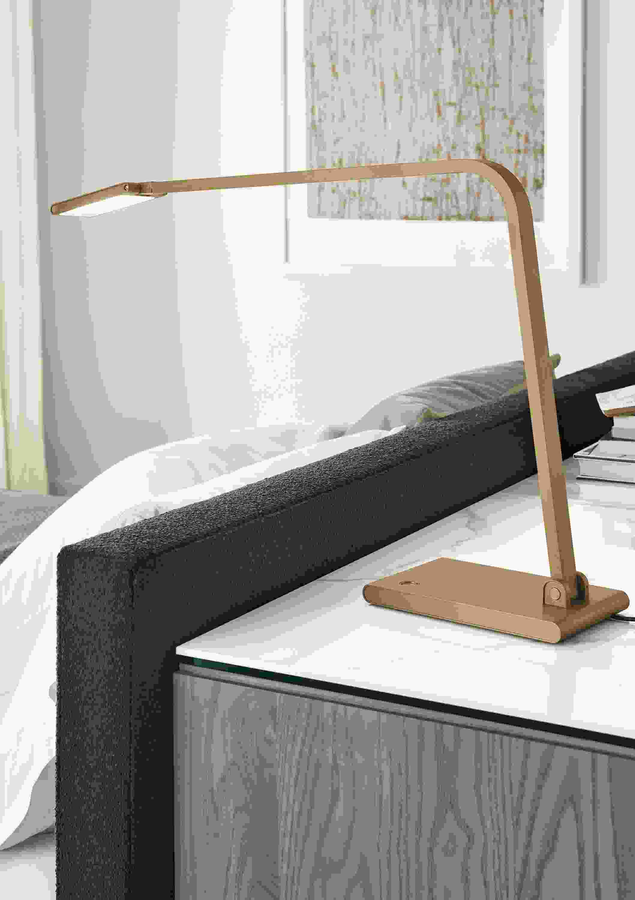Detail of Reach table lamp in brushed gold on dresser.