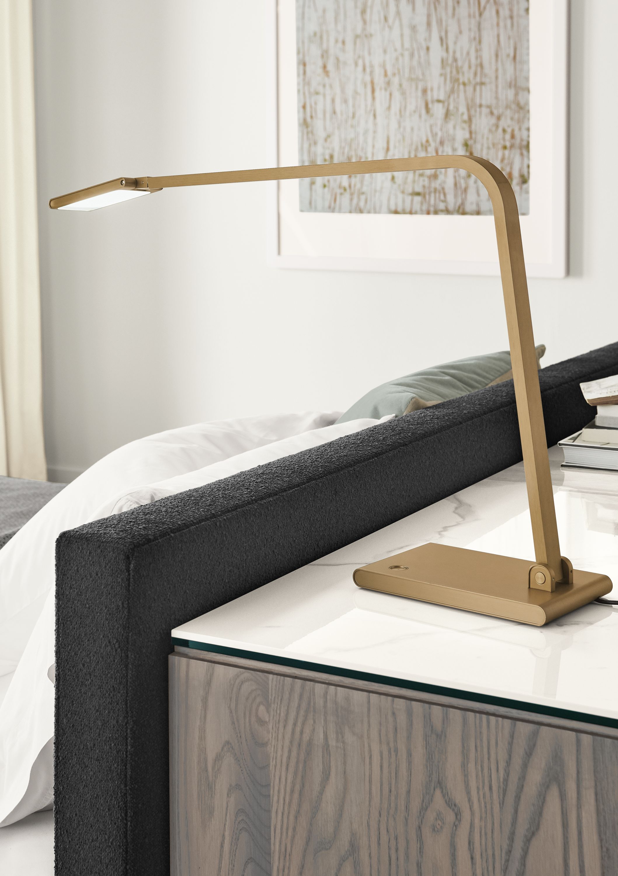 Detail of Reach table lamp in brushed gold on dresser.