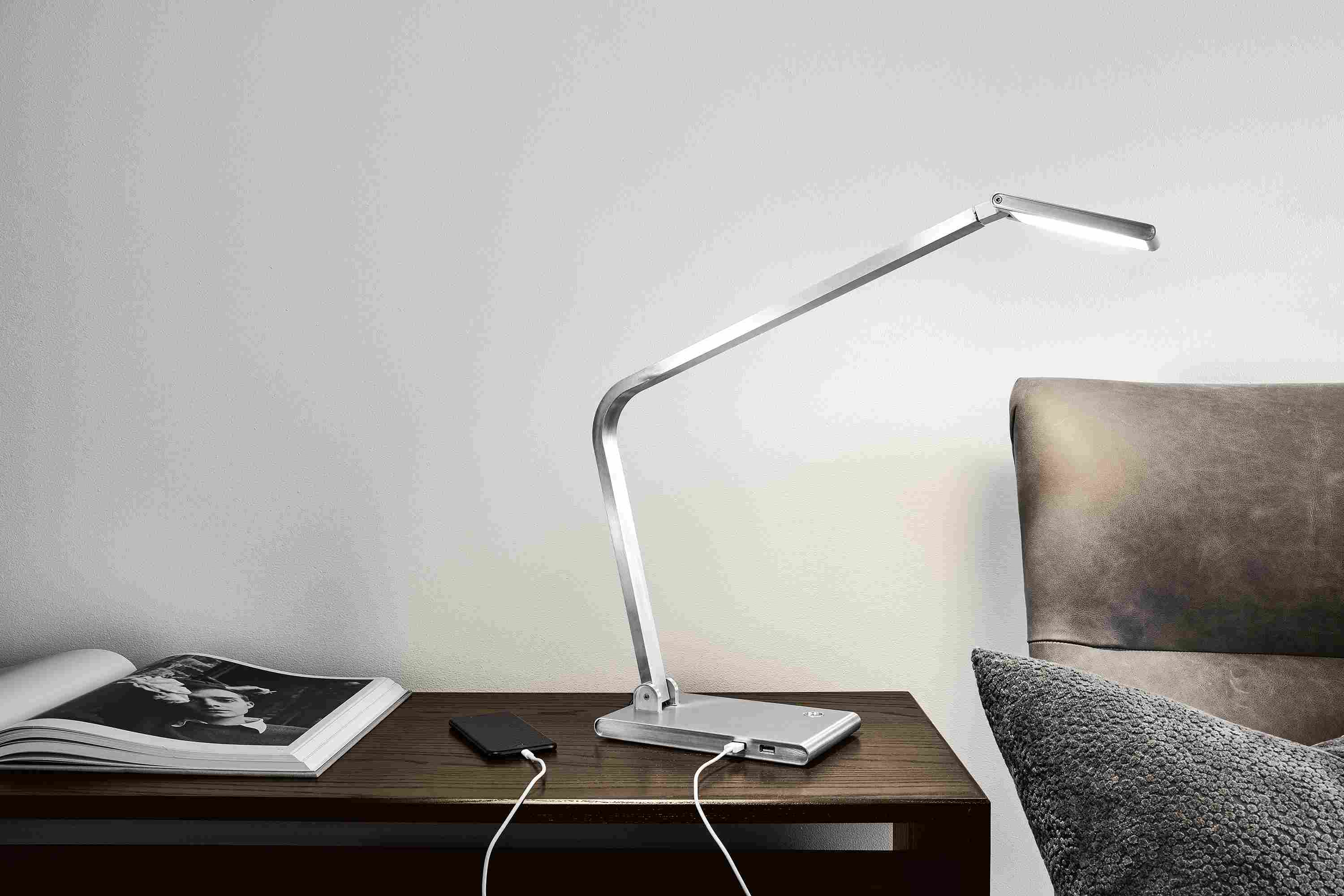 Detail of Reach table lamp in aluminum on a desk.