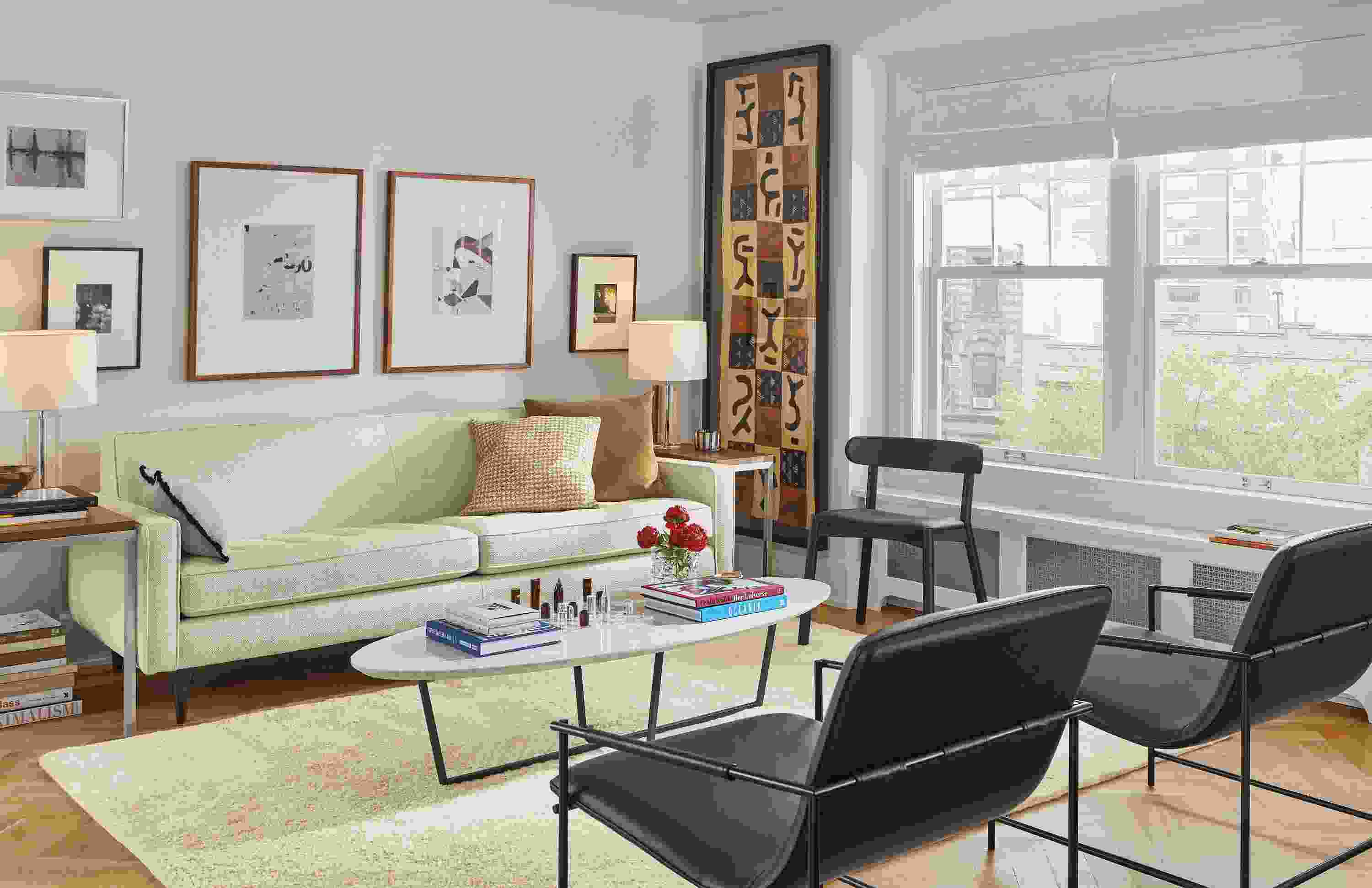 Living room featuring Reese two-cushion sofa in Orla Ivory fabric and two Dina lounge chairs in synthetic black leather.