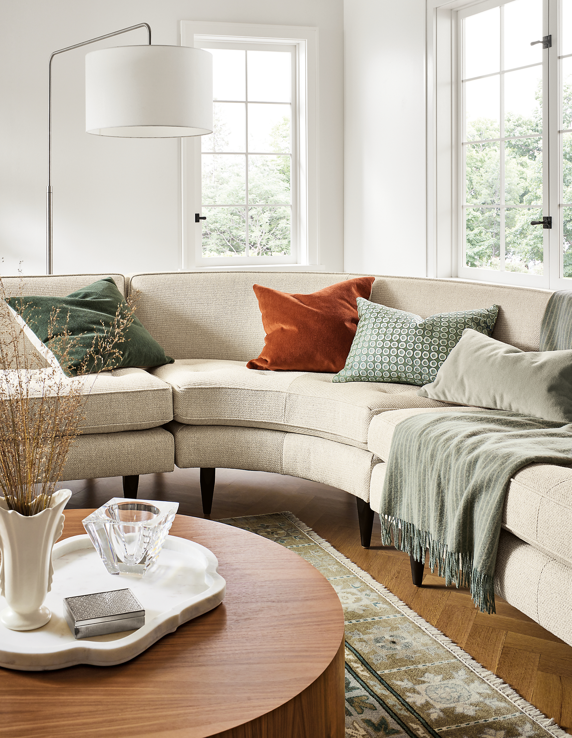 Living room with Reese sectional sofa in Orla Ivory, Liam coffee table in walnut and Kayseri rug in moss.