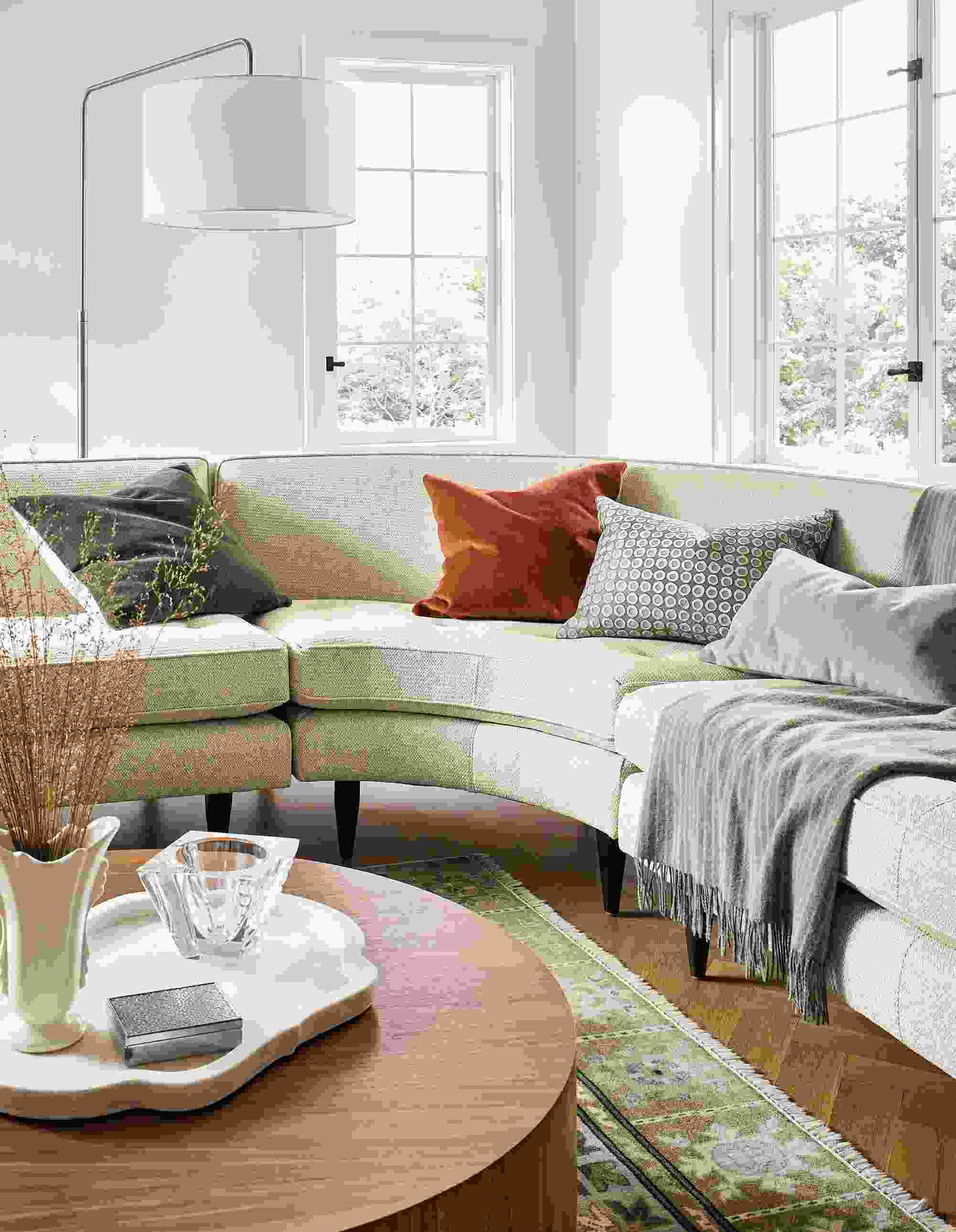 Living room with Reese sectional sofa in Orla Ivory, Liam coffee table in walnut and Kayseri rug in moss.