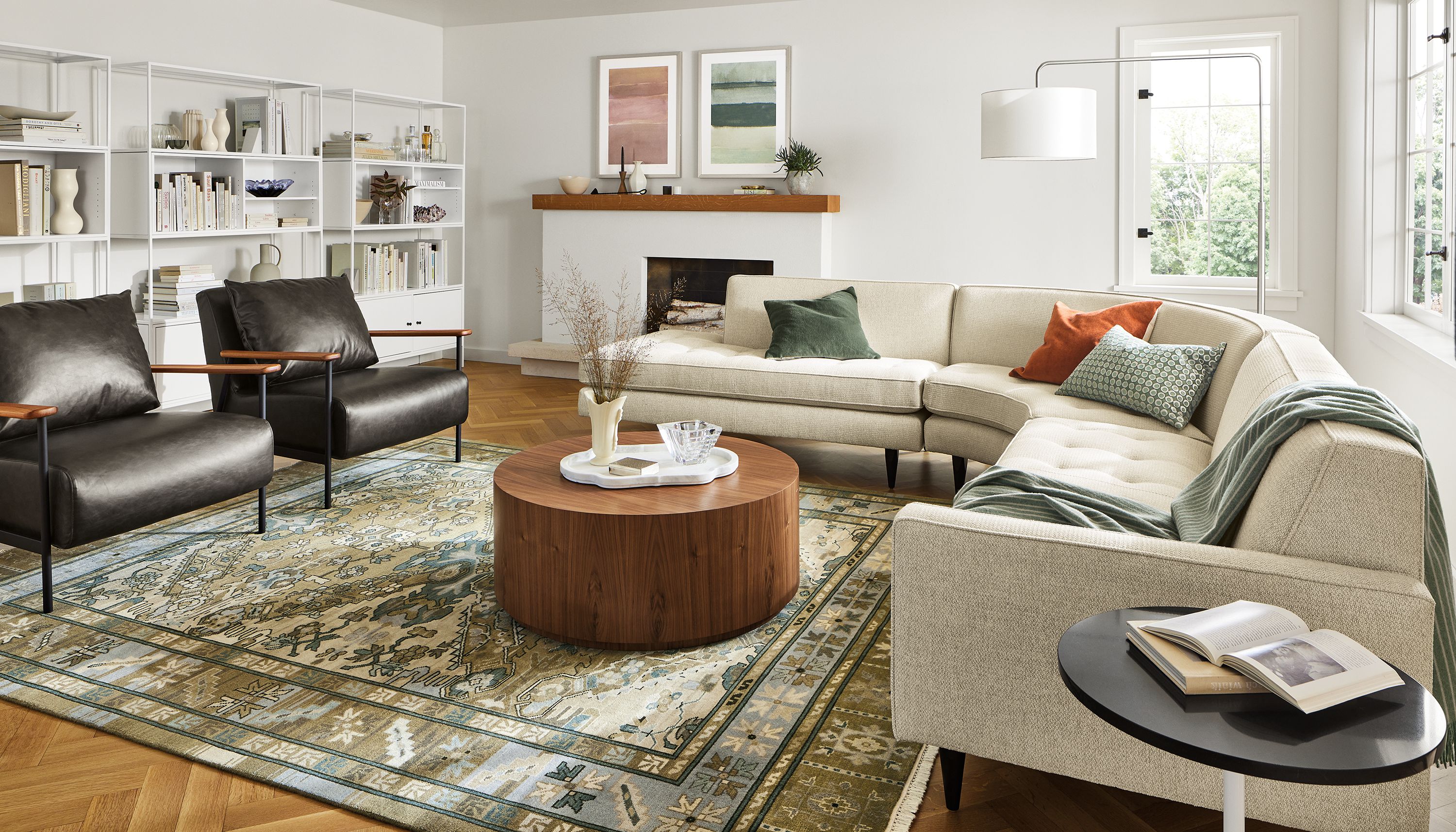 Living room with Reese 115-wide three-piece curved sectional in orla ivory, Xavier chair in Palermo charcoal leather.