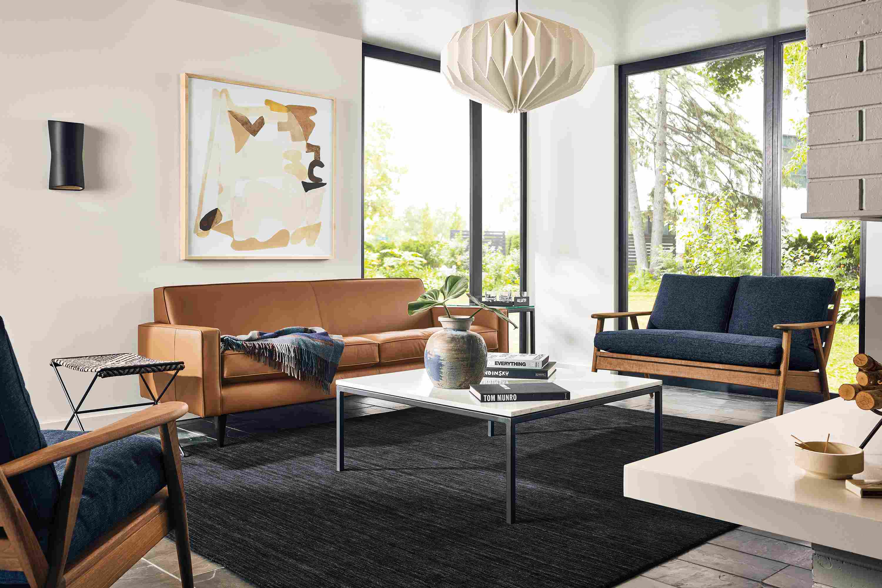 Living room with Reese sofa in Pesaro Cognac leather and Ericson loveseat and chair in sumner navy and walnut.