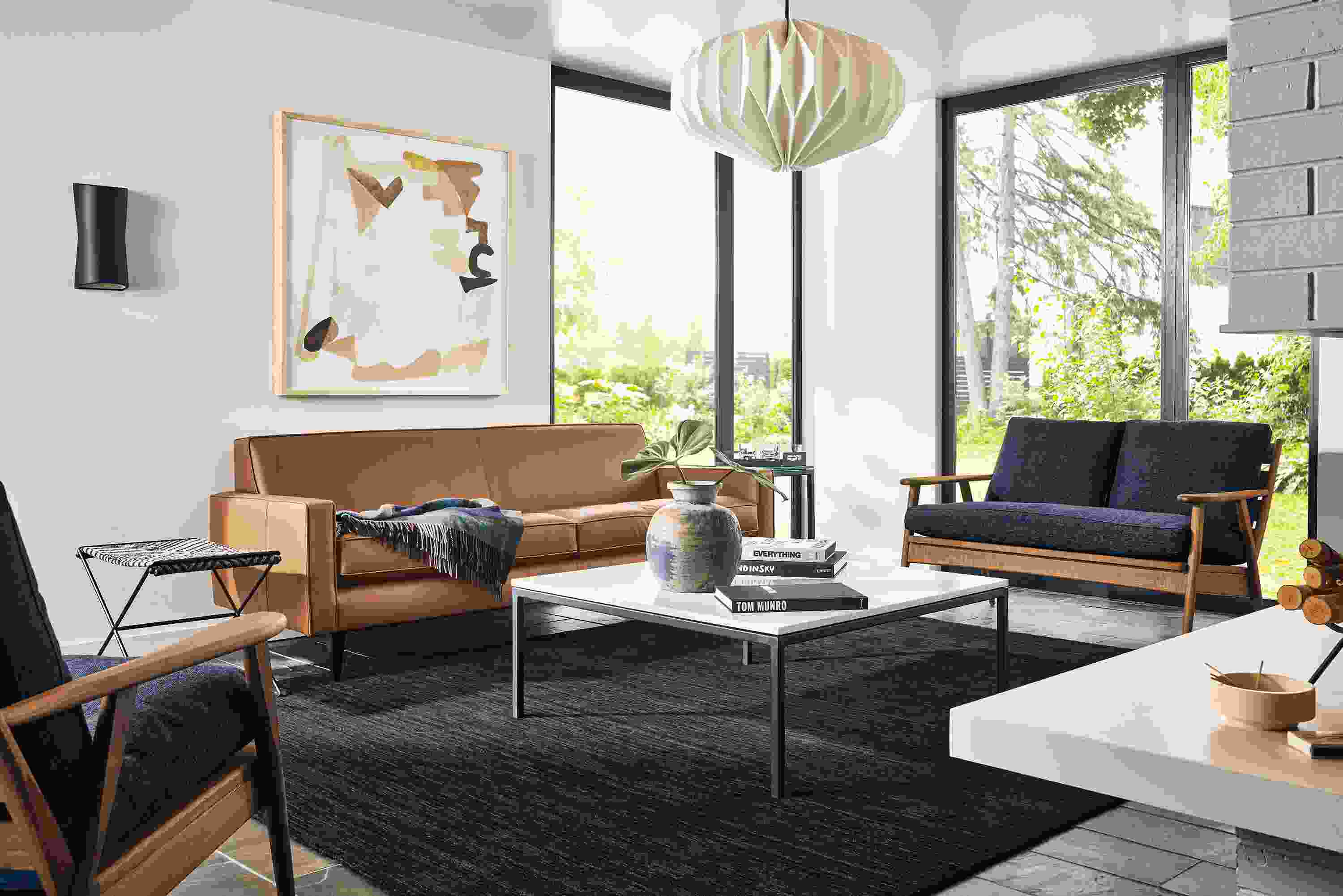 Living room with Reese sofa in Pesaro Cognac leather and Ericson loveseat and chair in sumner navy and walnut.