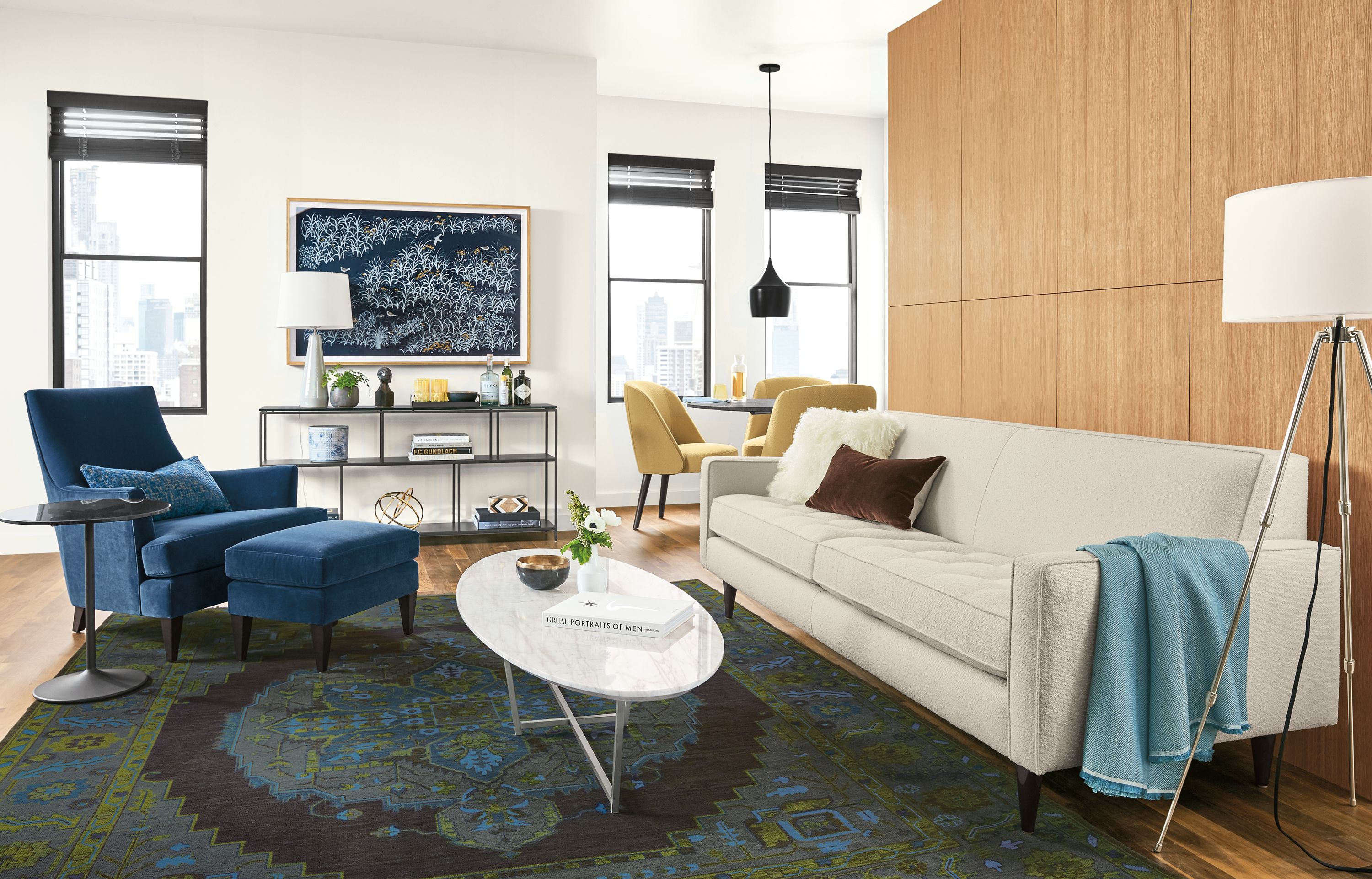 Living room with Reese sofa in Declan Ivory, Nadine chair and ottoman in Banks Denim and Heriz rug in ink.
