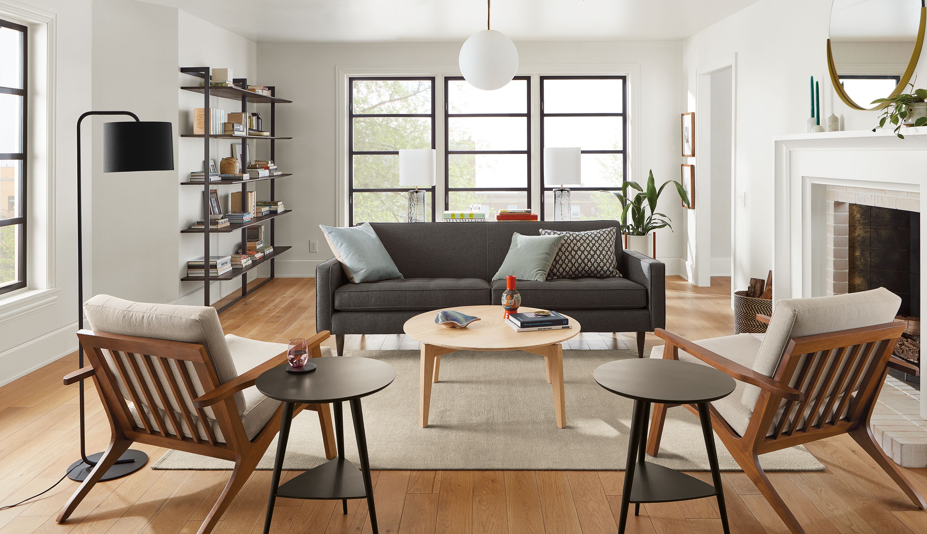 living room featuring reese sofa in gino charcoal fabric and two sanna chairs with walnut base and taupe cushions.