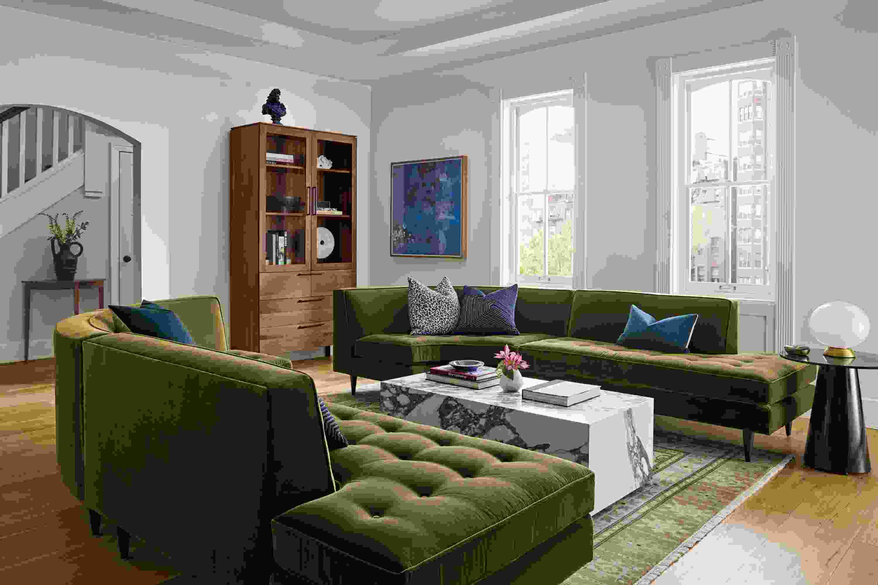 Large living room with 2 Reese curved sectional sofas in Redding Olive and a Leona coffee table in matte marbled white/charcoal.