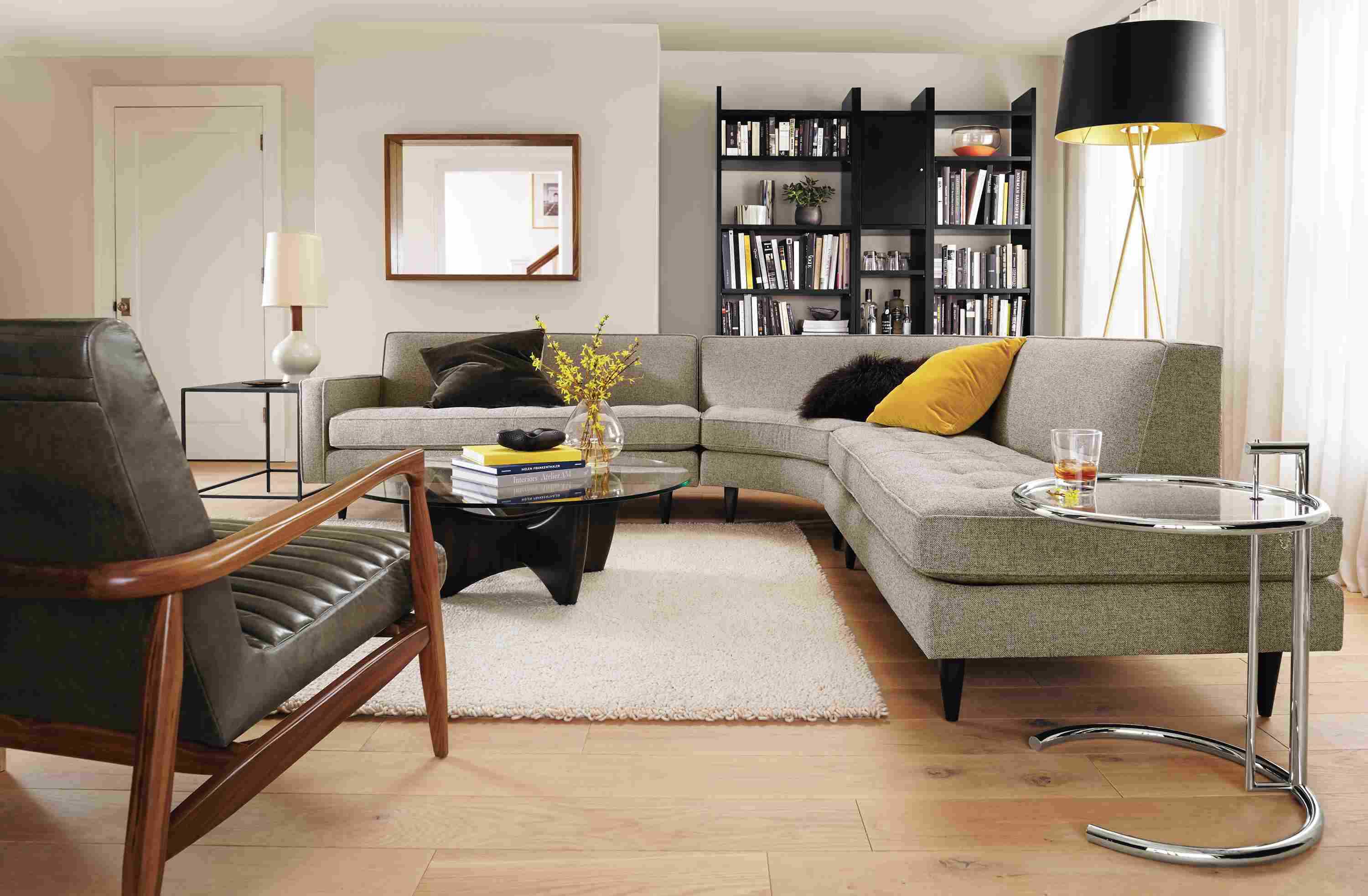 Living room with Reese 3-piece sectional in Tatum Grey, Callan chair in Lagoon Smoke leather and Arden rug in Ivory.