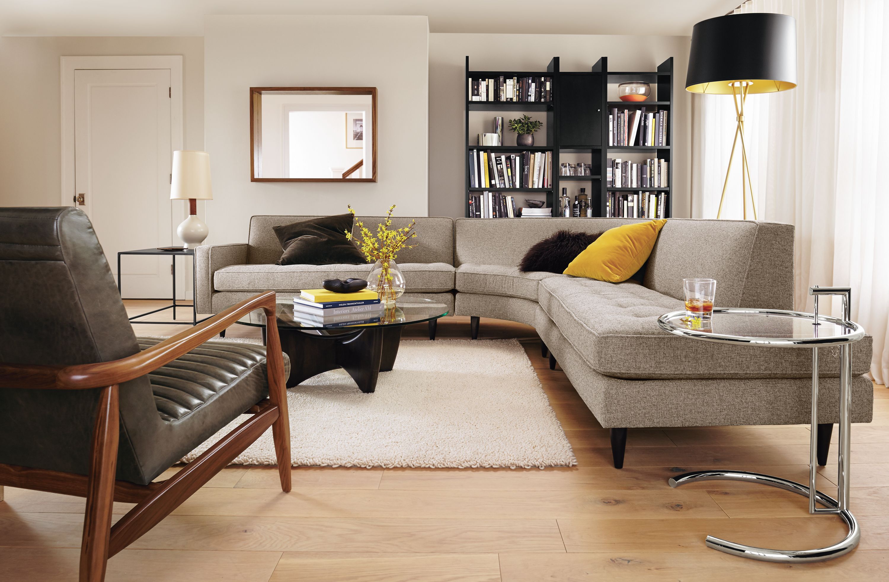 Living room with Reese 3-piece sectional in Tatum Grey, Callan chair in Lagoon Smoke leather and Arden rug in Ivory.