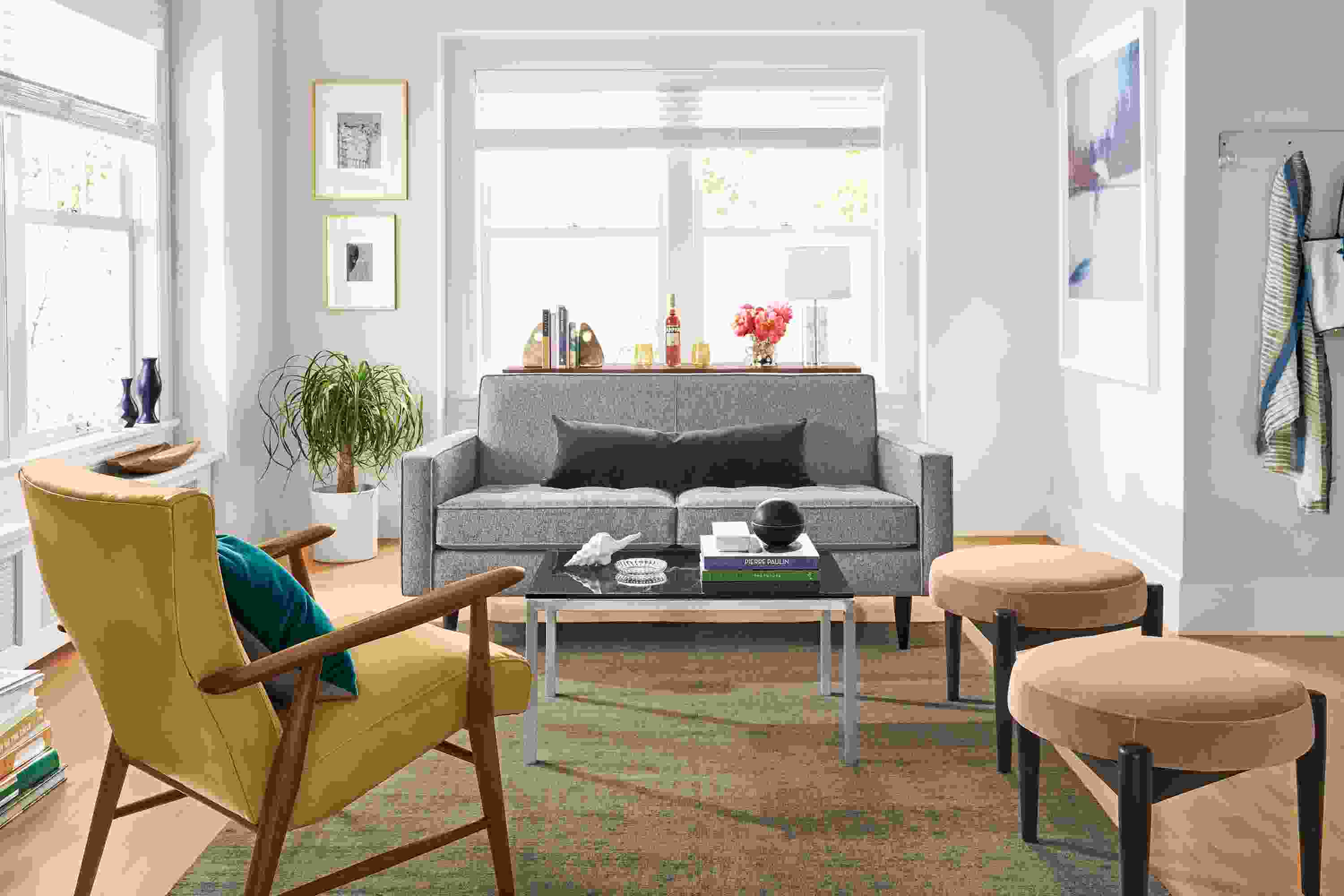 Living room with Reese sofa in Tatum Grey, Portica coffee table in stainless and Smoke Glass.