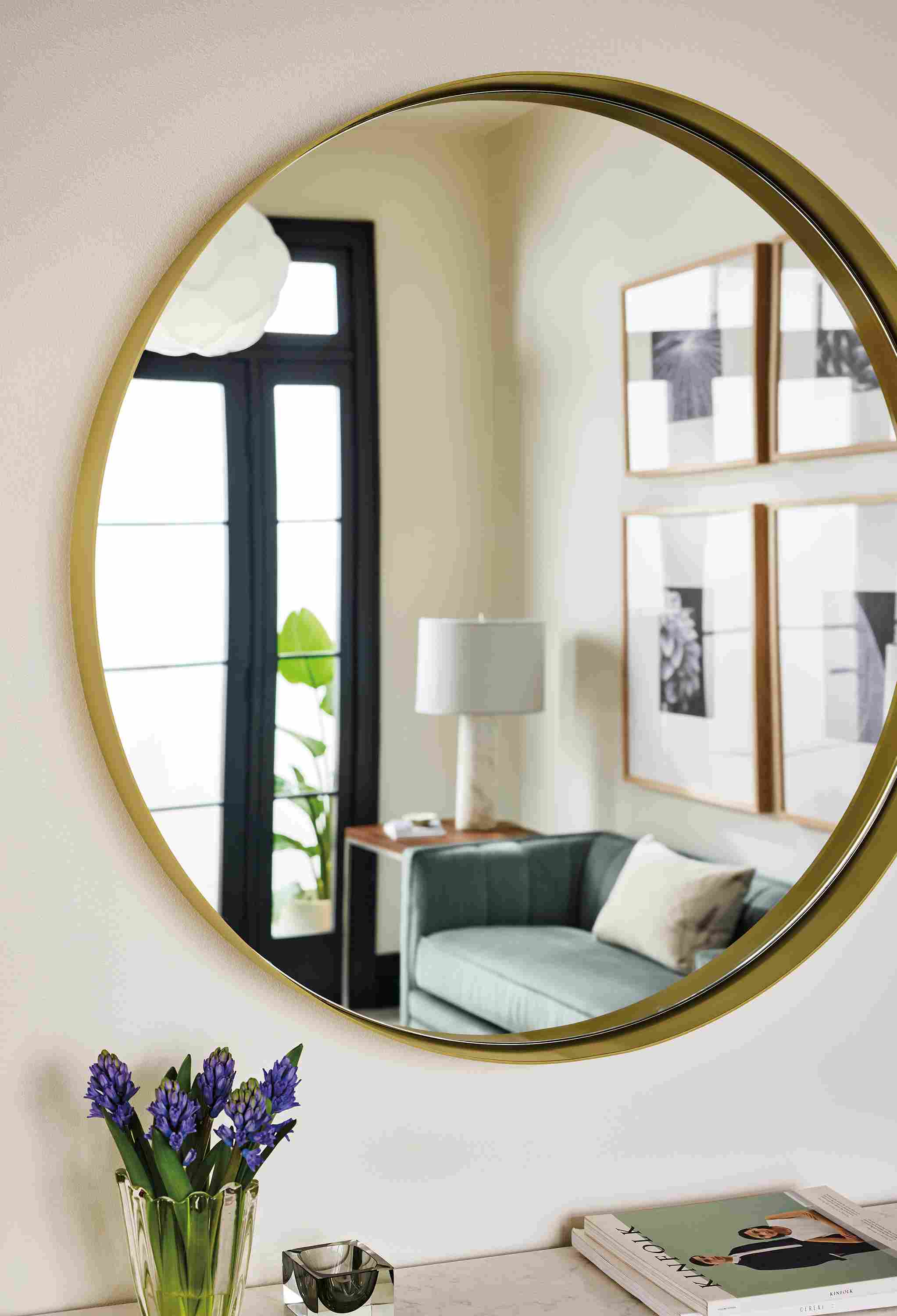 Detail of reeves 36.5-diameter mirror in brushed gold and reflection of Carlisle 60-wide bench in Windsor Cloud.