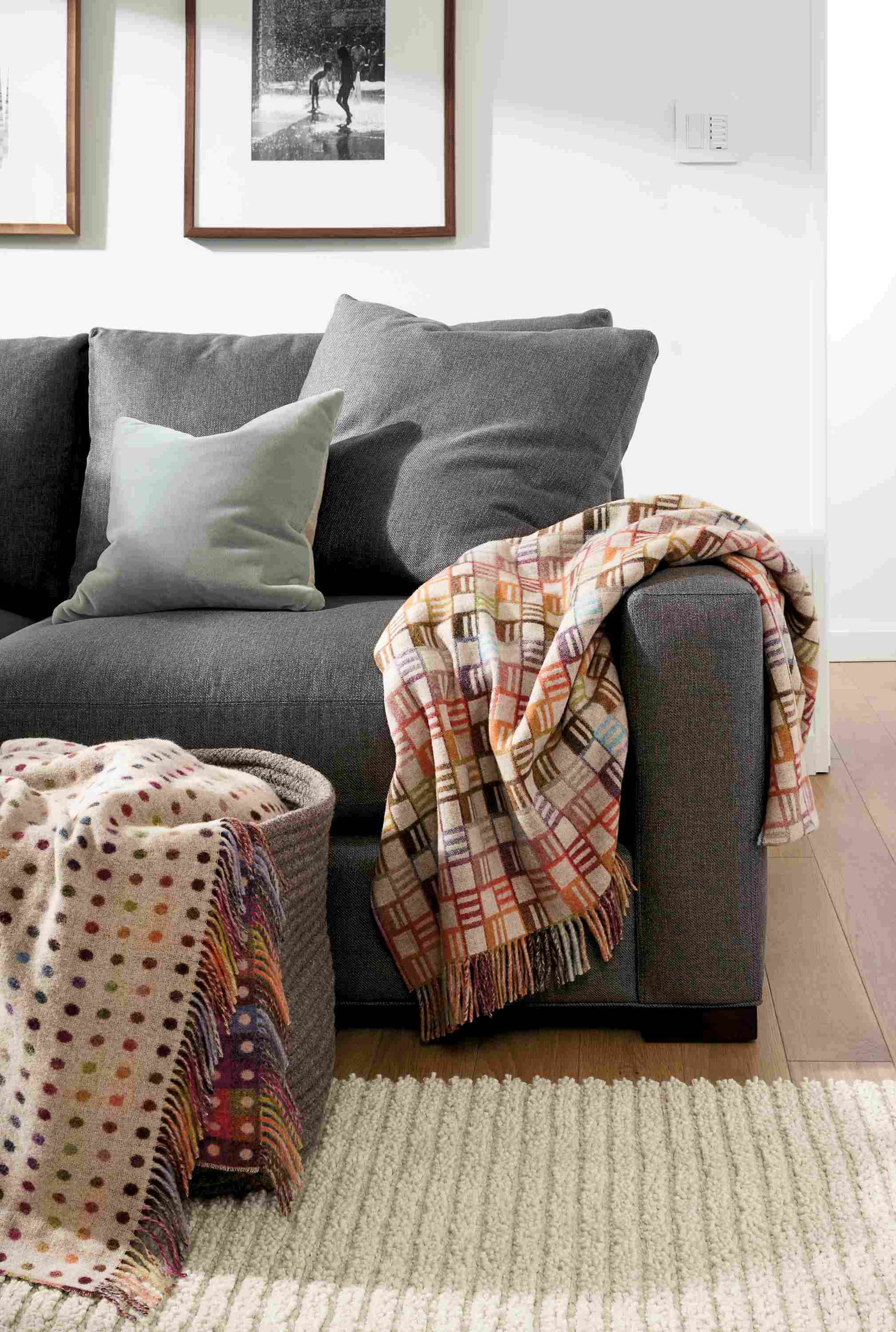 Living room with Remy and Zoe throw blankets in multicolor and Arden ribbed rug in oatmeal.