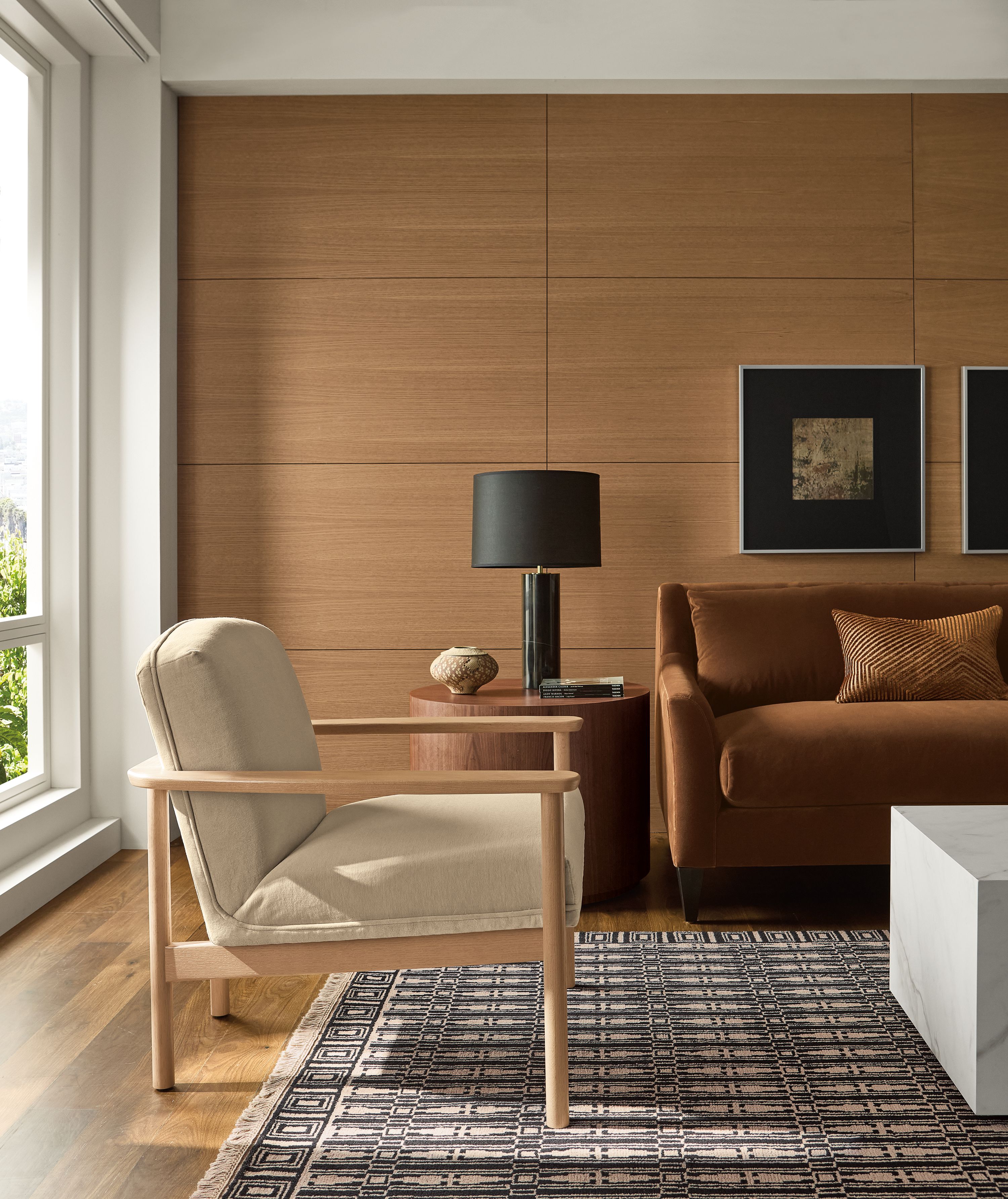 Sunny living room with Renew chair in Terra Oatmeal, Sybil sofa in Redding Nutmeg and an 8 by 10 rug in ebony