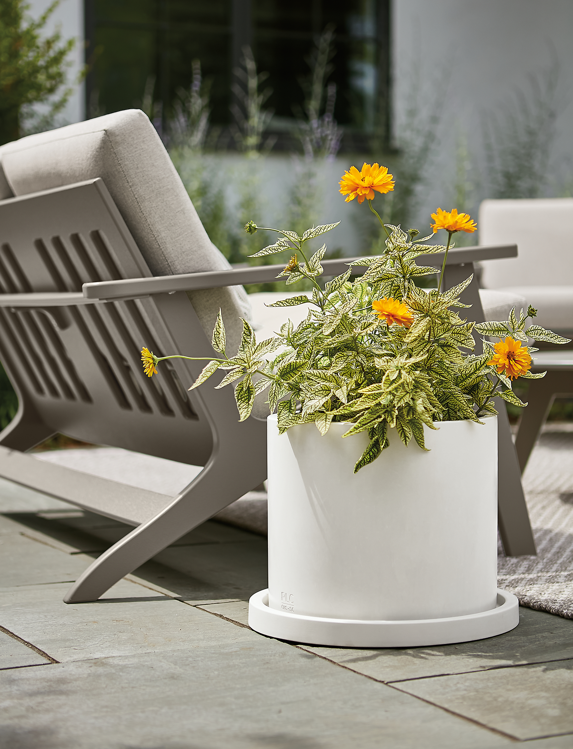 renga planter in white on stone patio outdoors.