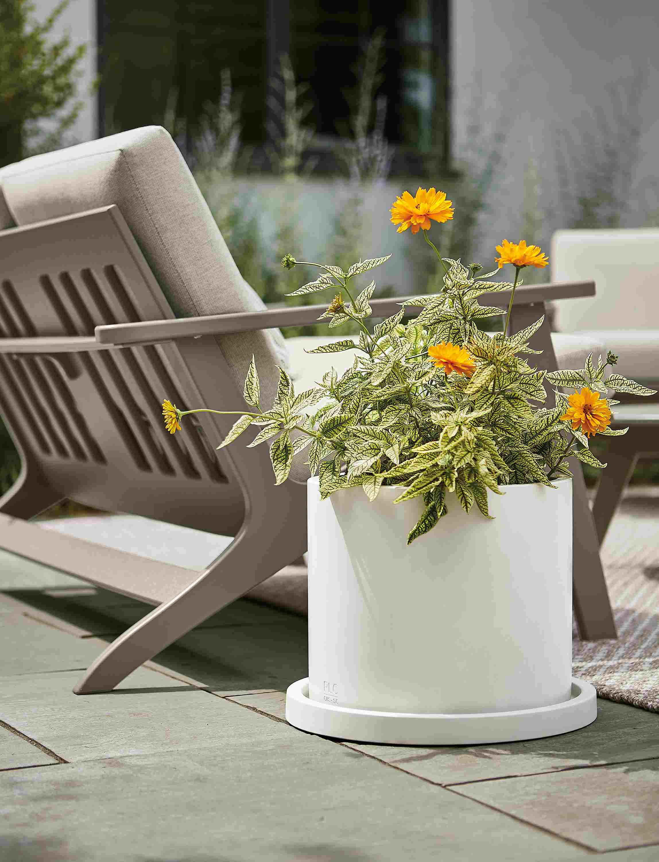 Renga planter in white on stone patio outdoors.