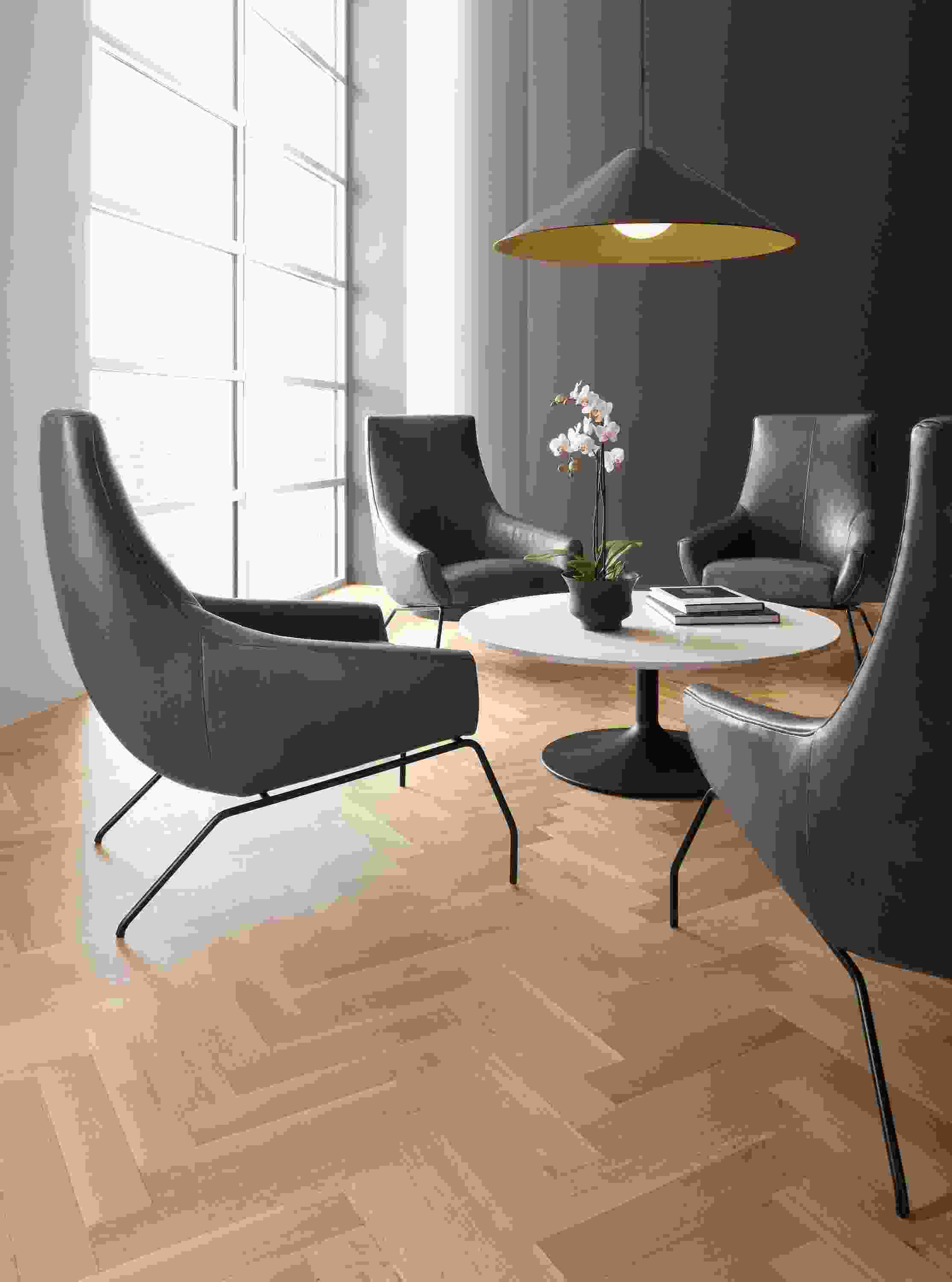 Rhodes leather chairs in Vento smoke with Aria coffee table in graphite base with White top.