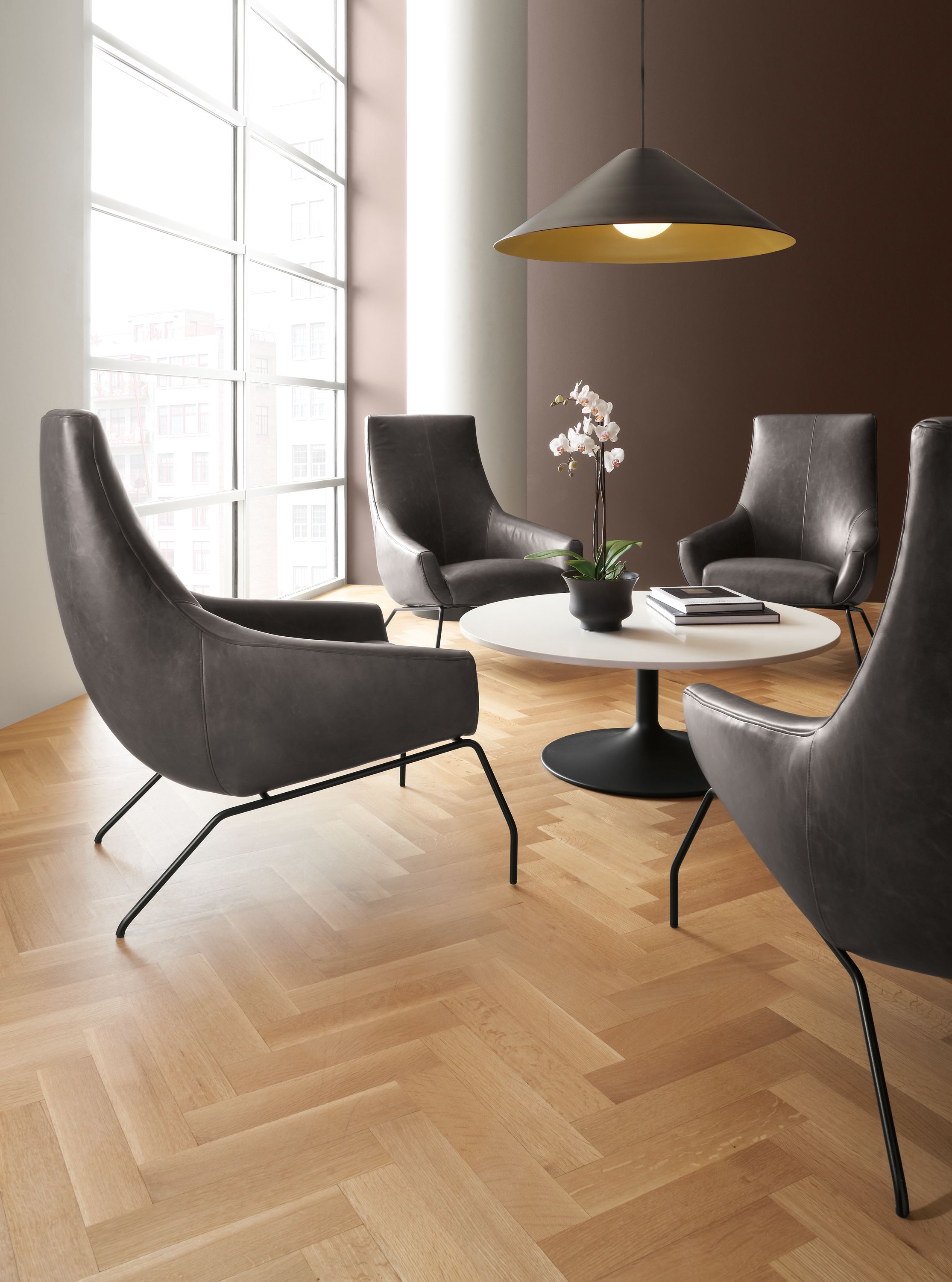 Rhodes leather chairs in Vento smoke with Aria coffee table in graphite base with White top.