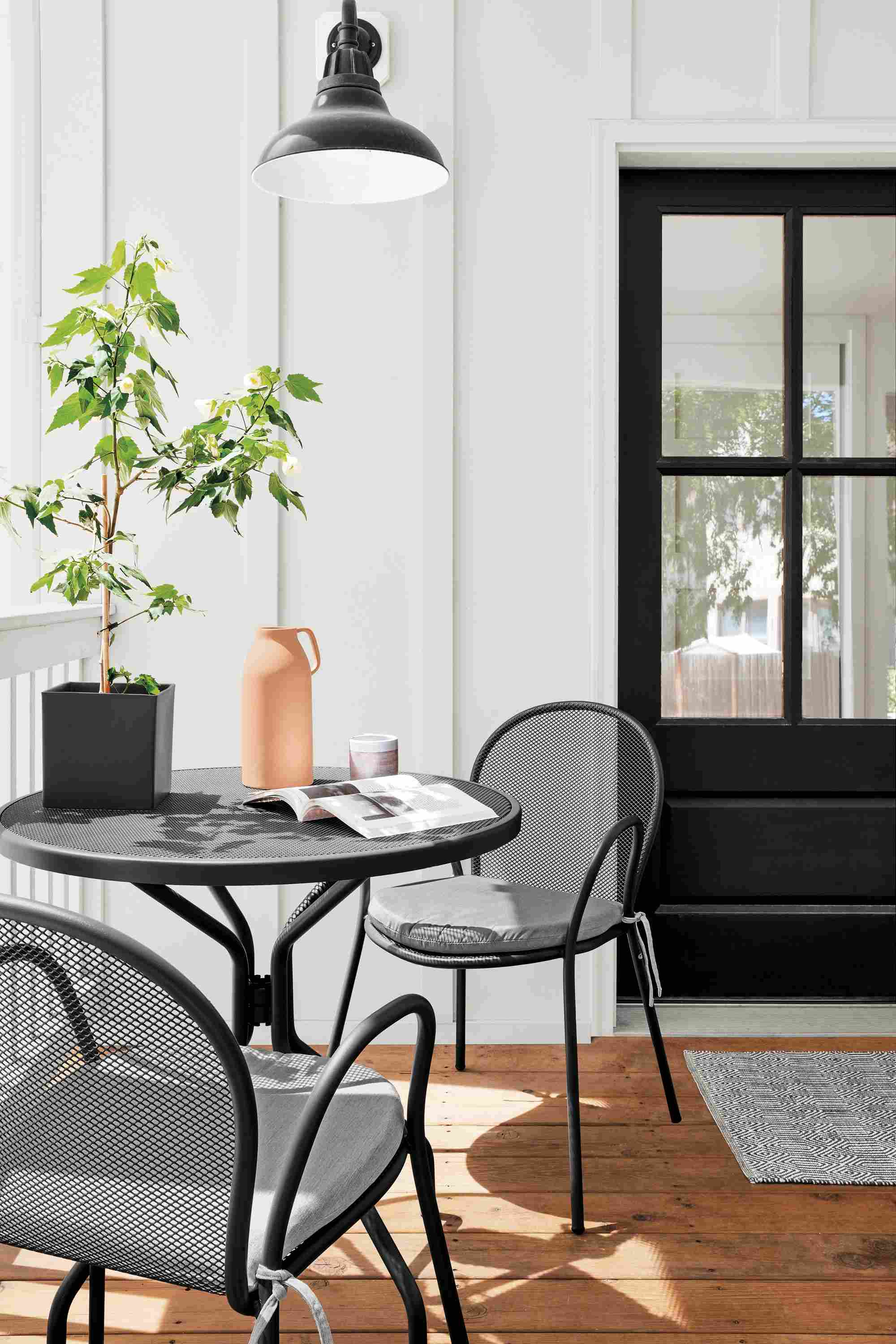 Deck with 2 Rio chairs in graphite with Sunbrella Canvas cushions and Kona round table in graphite.