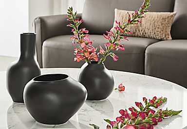 detail of ripple vases in black with flowers on coffee table
