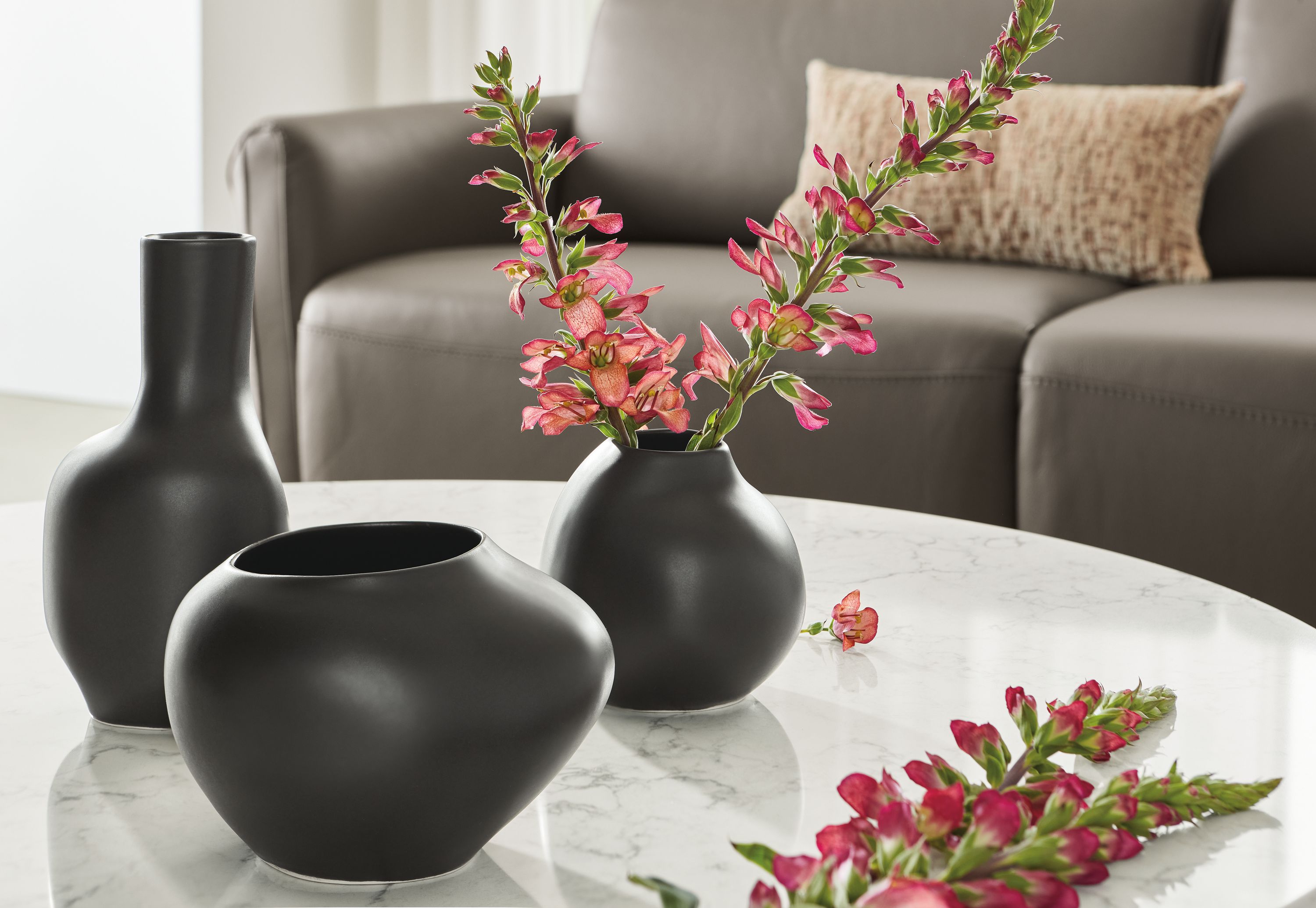 detail of ripple vases in black with flowers on coffee table