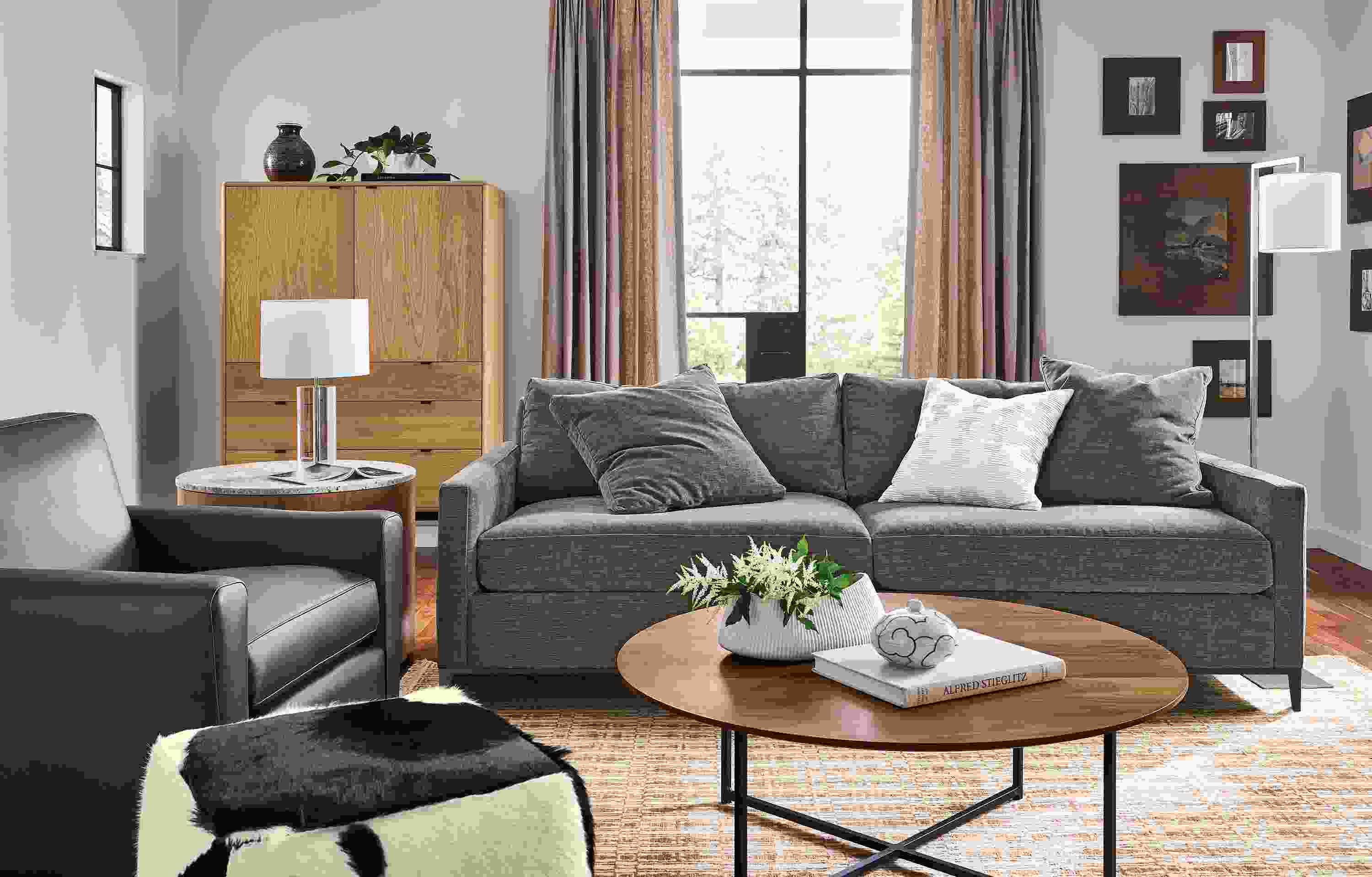 Living room with 91-wide Mori sofa in Mori Graphite, Seth chair in Laino Black Leather and classic coffee table in walnut.