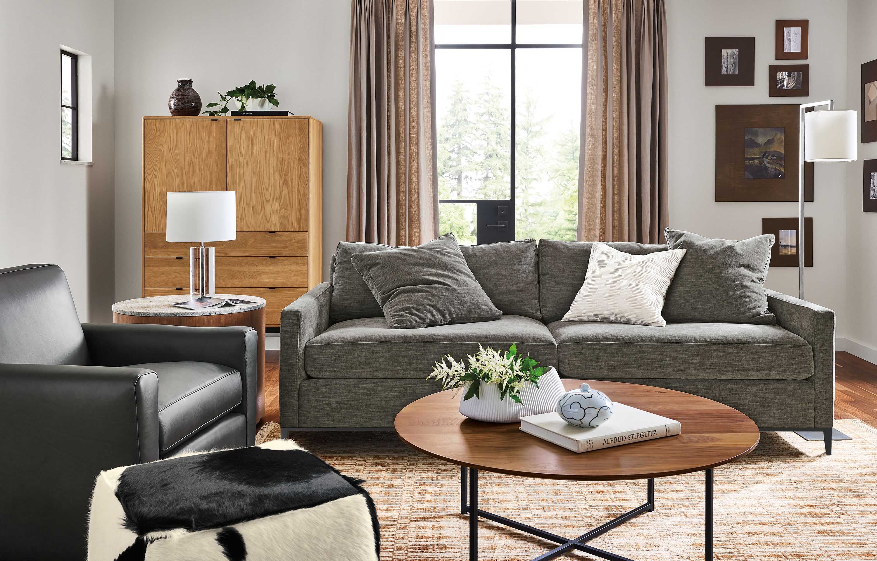 Living room with 91-wide Mori sofa in Mori Graphite, Seth chair in Laino Black Leather and classic coffee table in walnut.