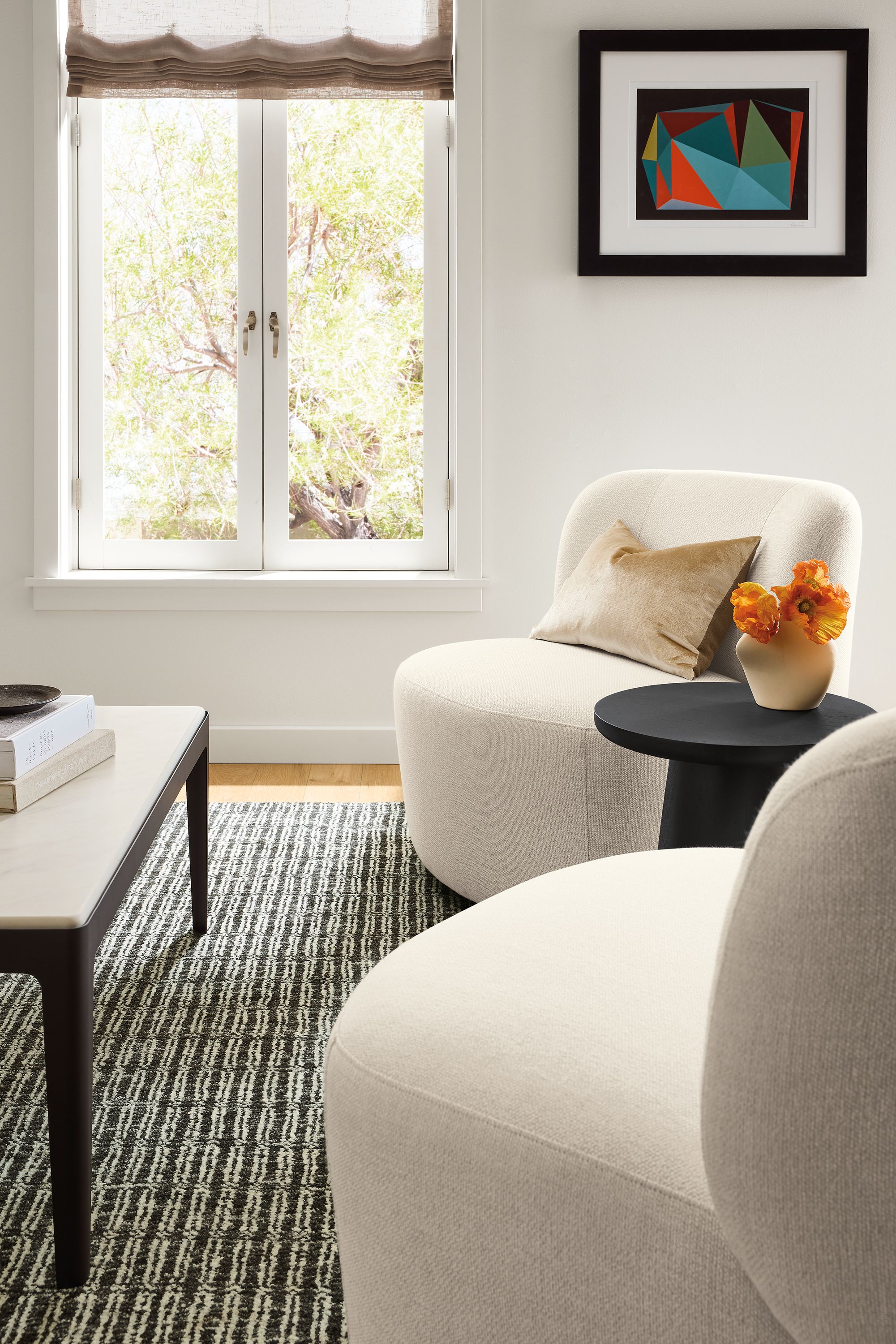 Living room with 2 Rory swivel chairs in Tepic Ivory and a Belmar coffee table in graphite and marbled warm white quartz.