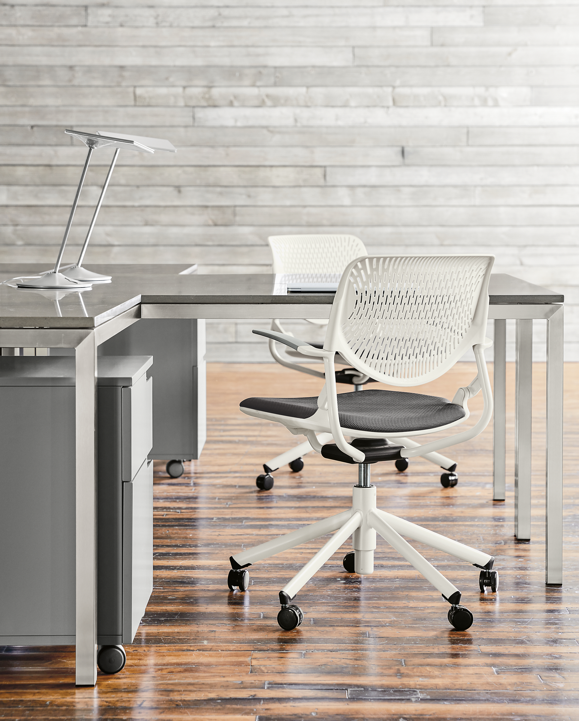 Detail of Runa swivel office chairs in white with grey seat.