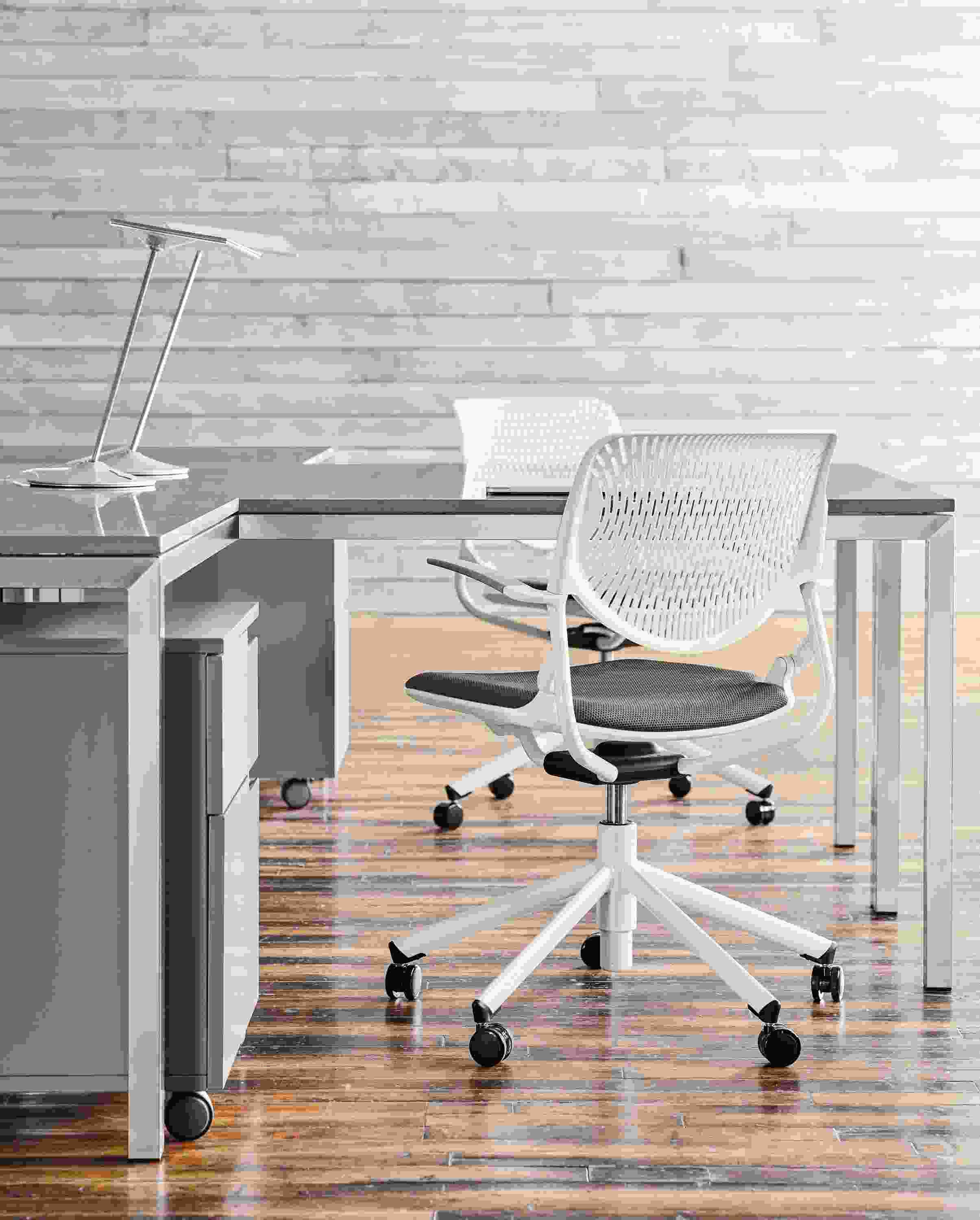 Detail of Runa swivel office chairs in white with grey seat.