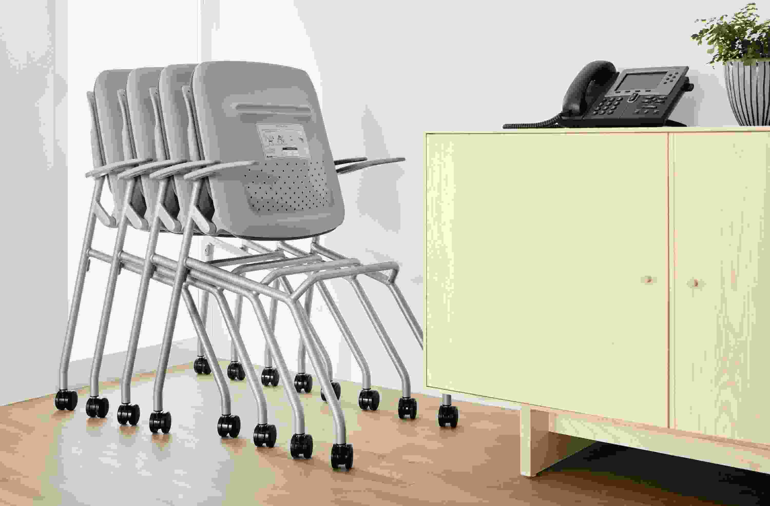 Group of Runa nesting office chairs shown nested together.