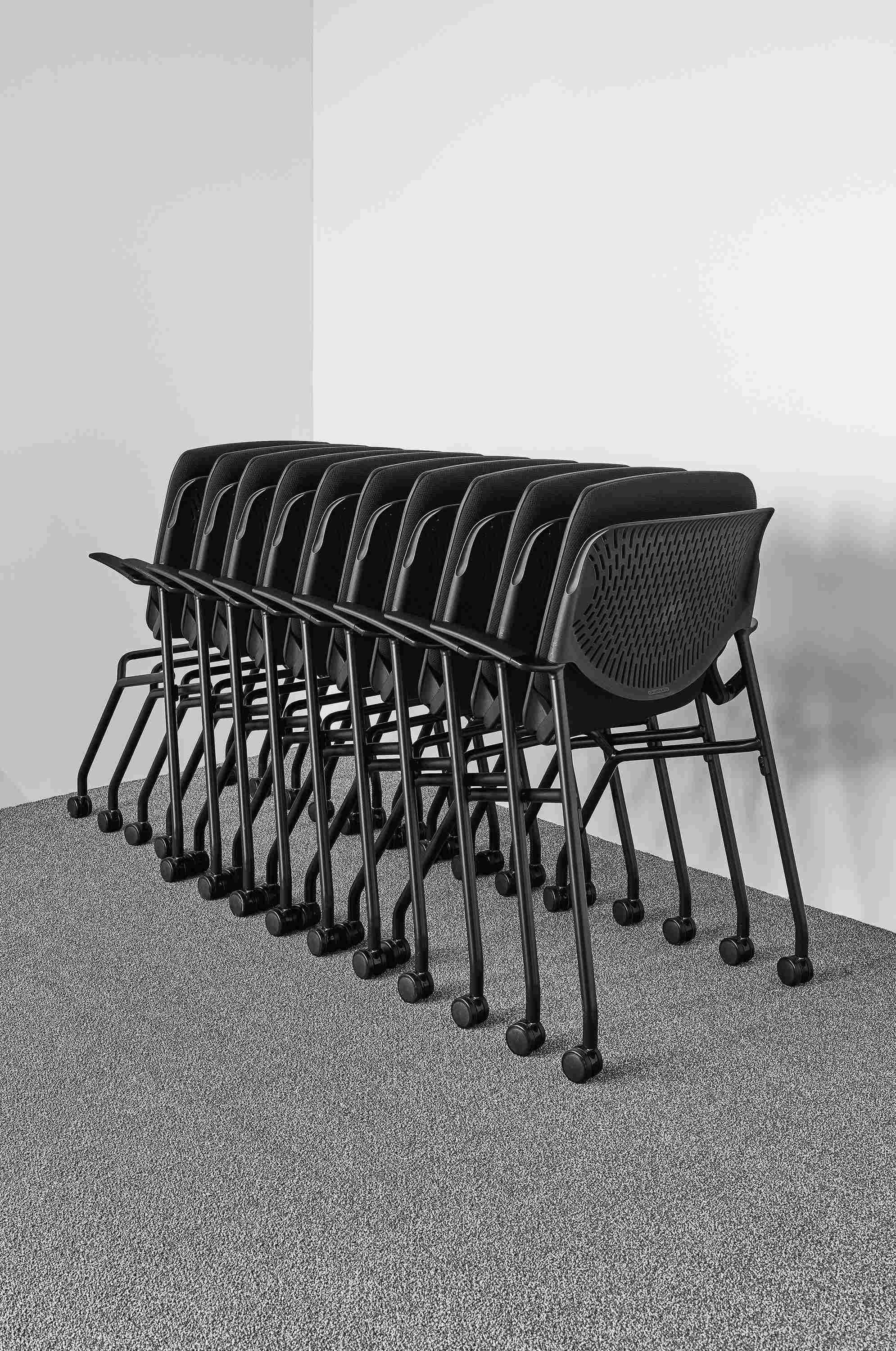 Detail of Runa nesting office chairs nested in office corner.