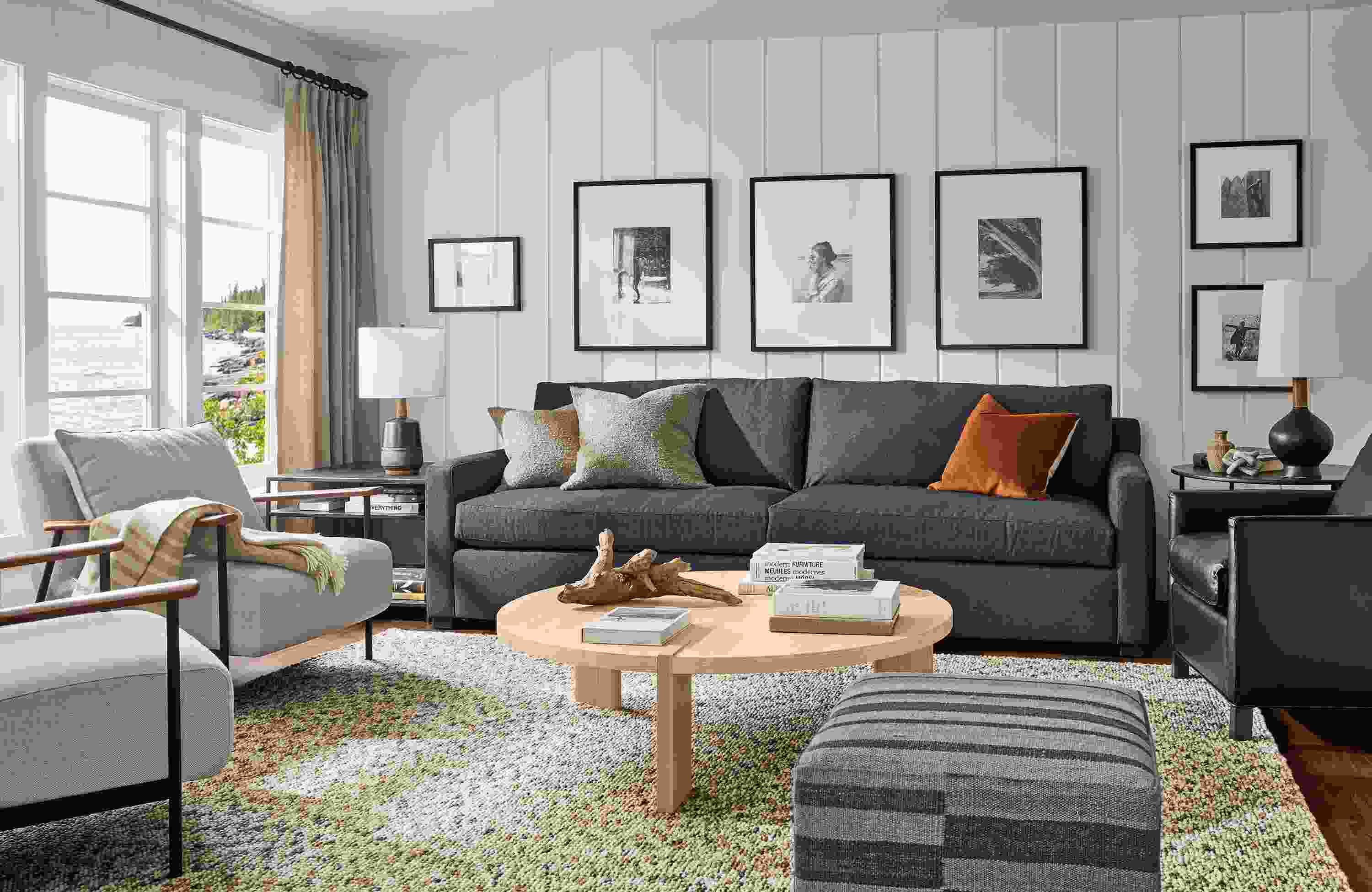 Living room with Ryan 106-wide sofa in Myers Navy, 2 Xavier chairs in Gino Oatmeal and Hanover round coffee table in salt on red oak.