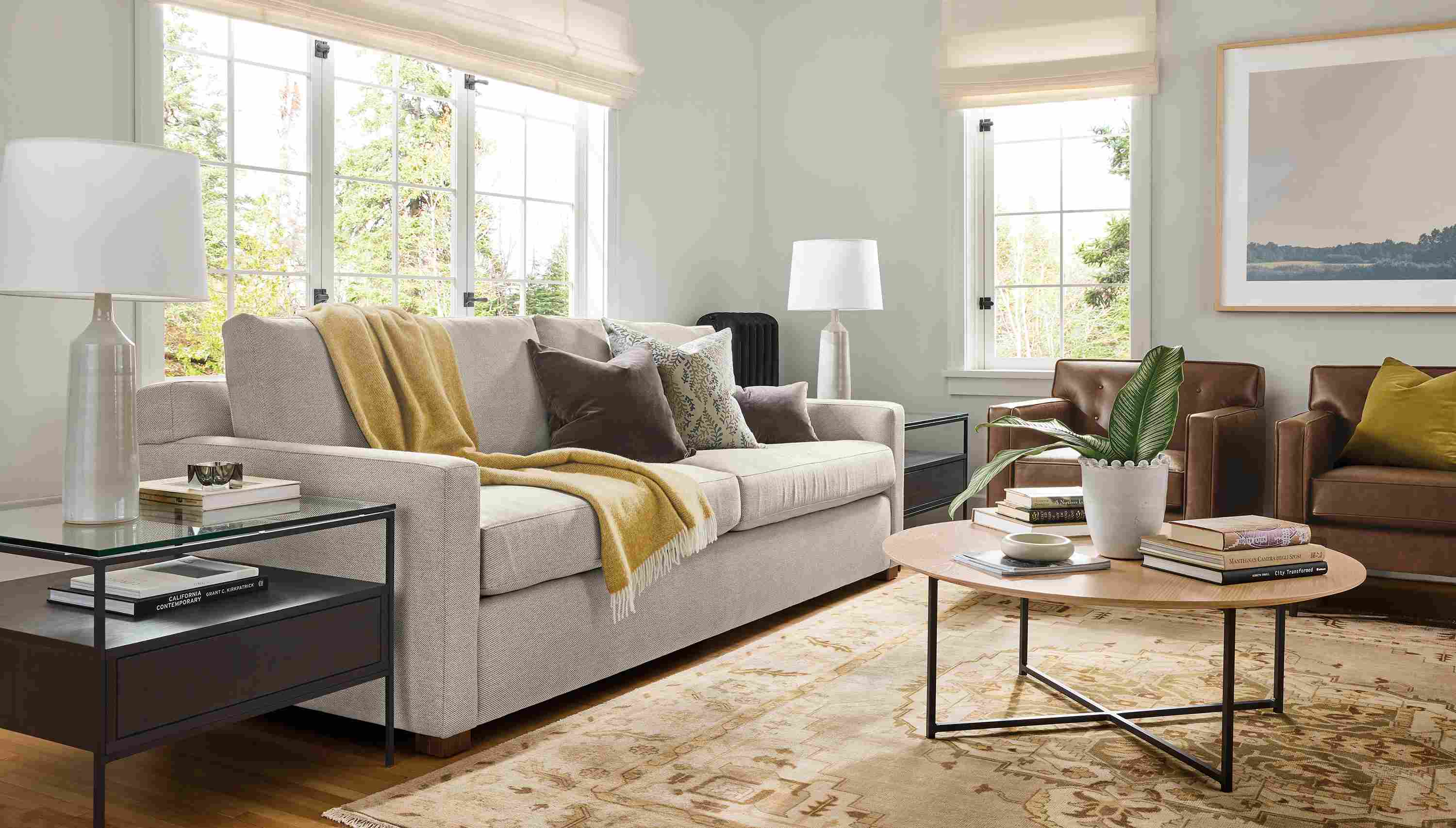 Living room with Ryan 96-wide sofa in Derry Natural, 2 Holmes chairs in Palermo Bourbon leather and Heriz rug in Opal.
