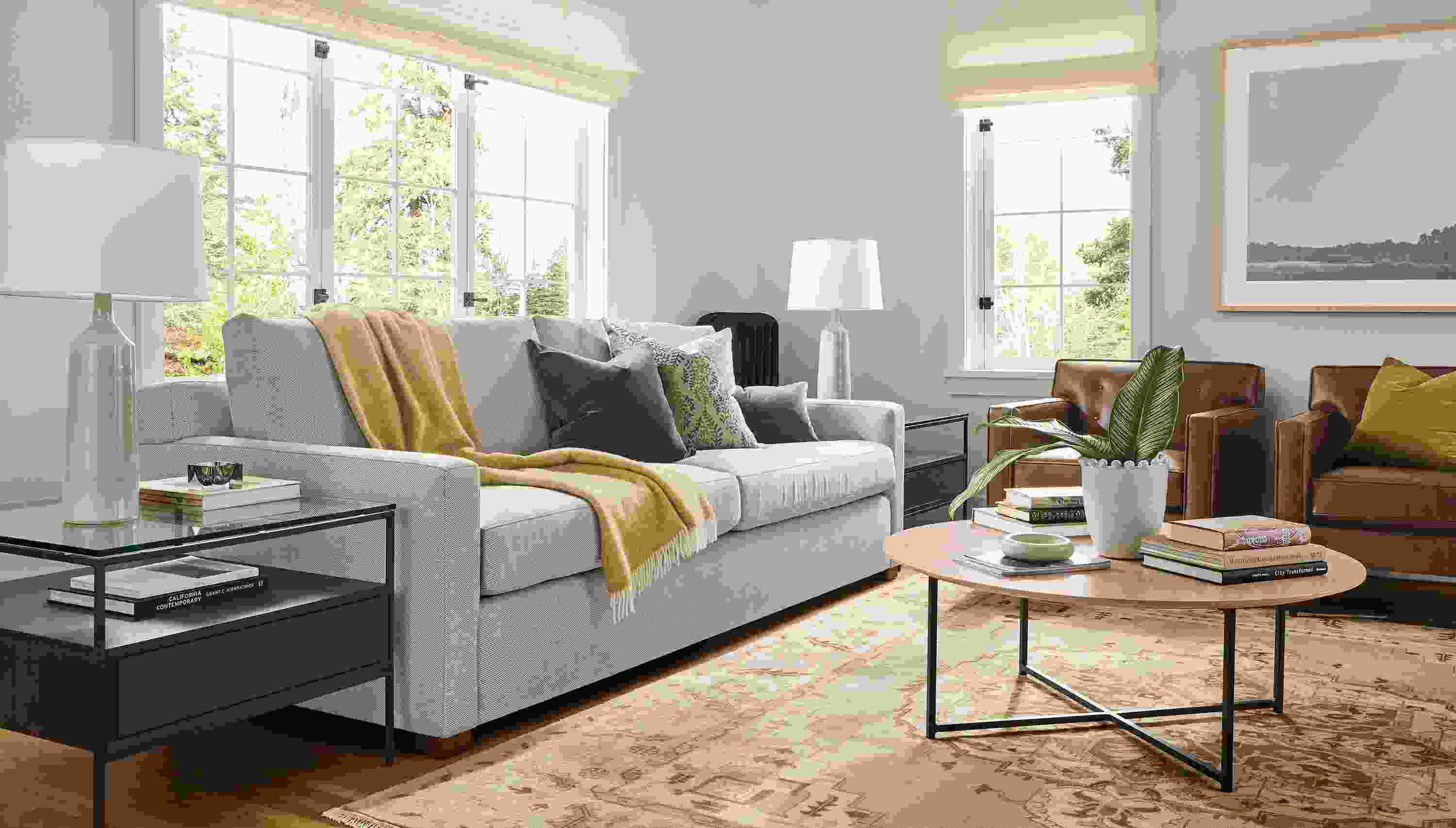 Living room with Ryan 96-wide sofa in Derry Natural, 2 Holmes chairs in Palermo Bourbon leather and Heriz rug in Opal.