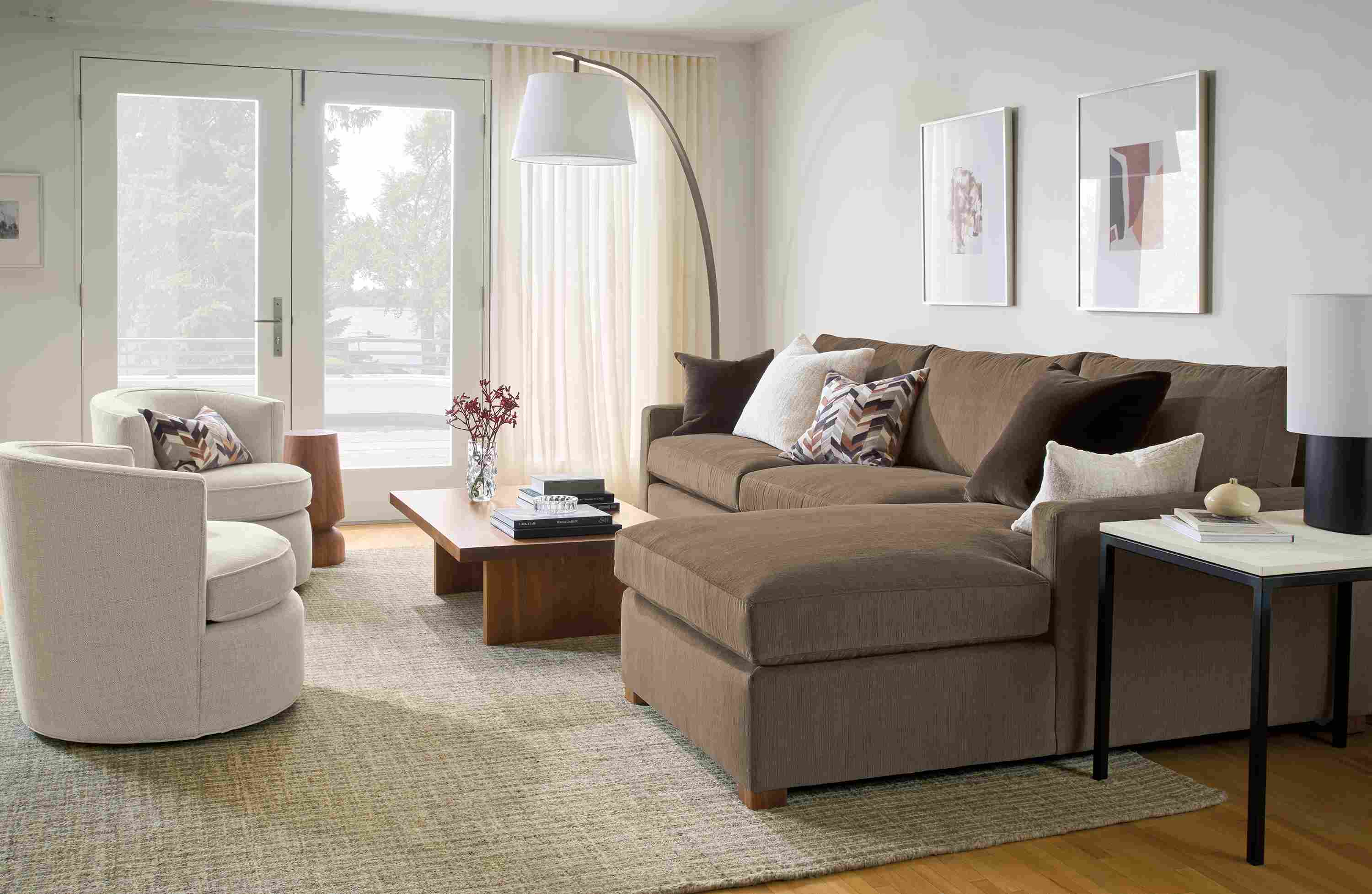 Living room with Ryan 118-wide sofa in Nigel Otter, 2 swivel chairs in Olmsted Natural and Corbett coffee table in walnut.