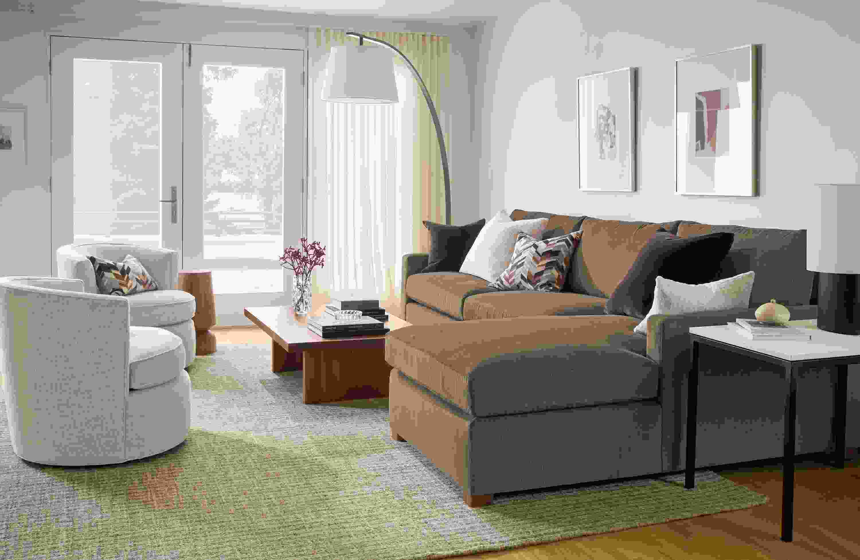 Living room with Ryan 118-wide sofa in Nigel Otter, 2 swivel chairs in Olmsted Natural and Corbett coffee table in walnut.