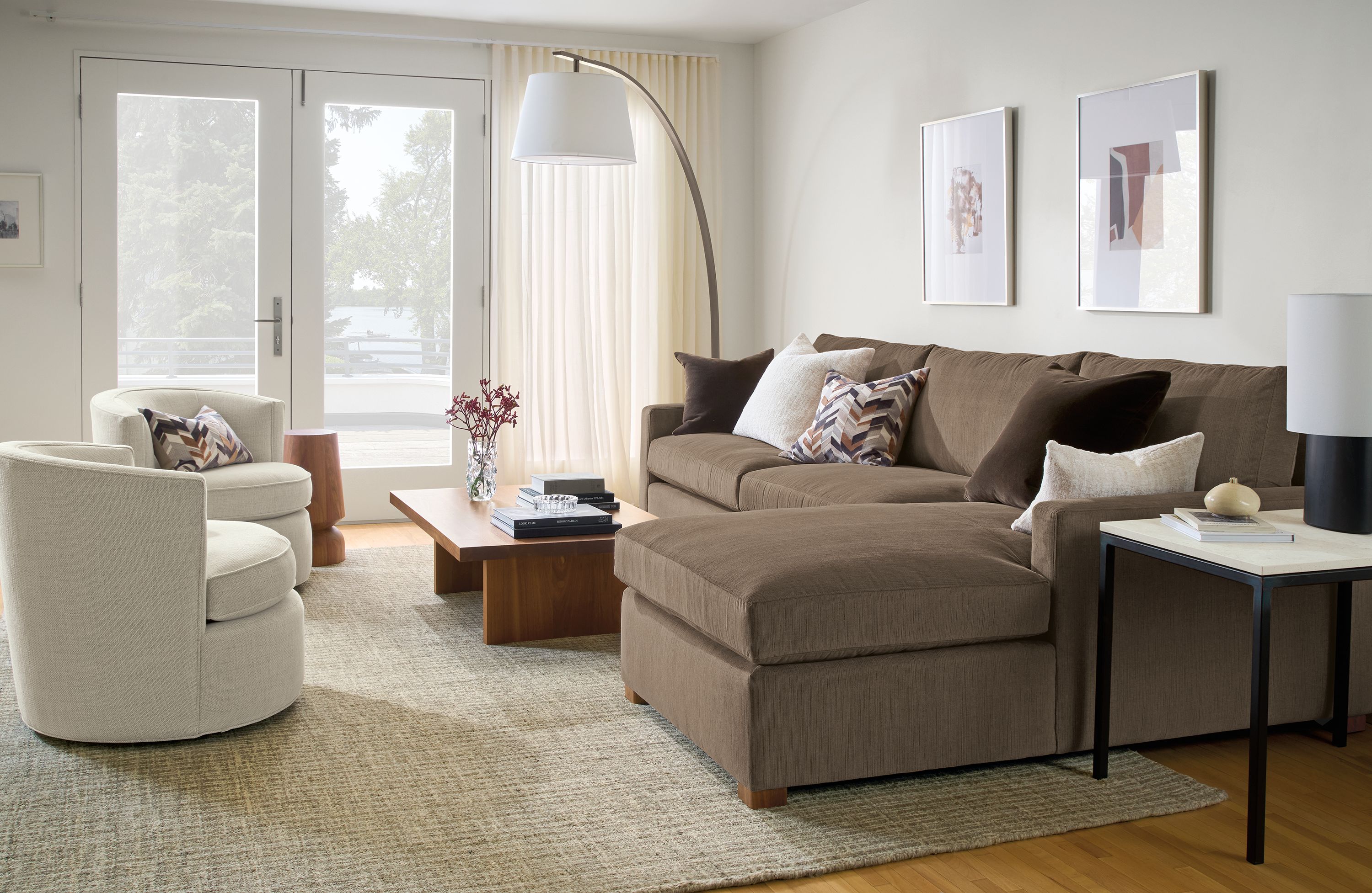 Living room with Ryan 118-wide sofa in Nigel Otter, 2 swivel chairs in Olmsted Natural and Corbett coffee table in walnut.