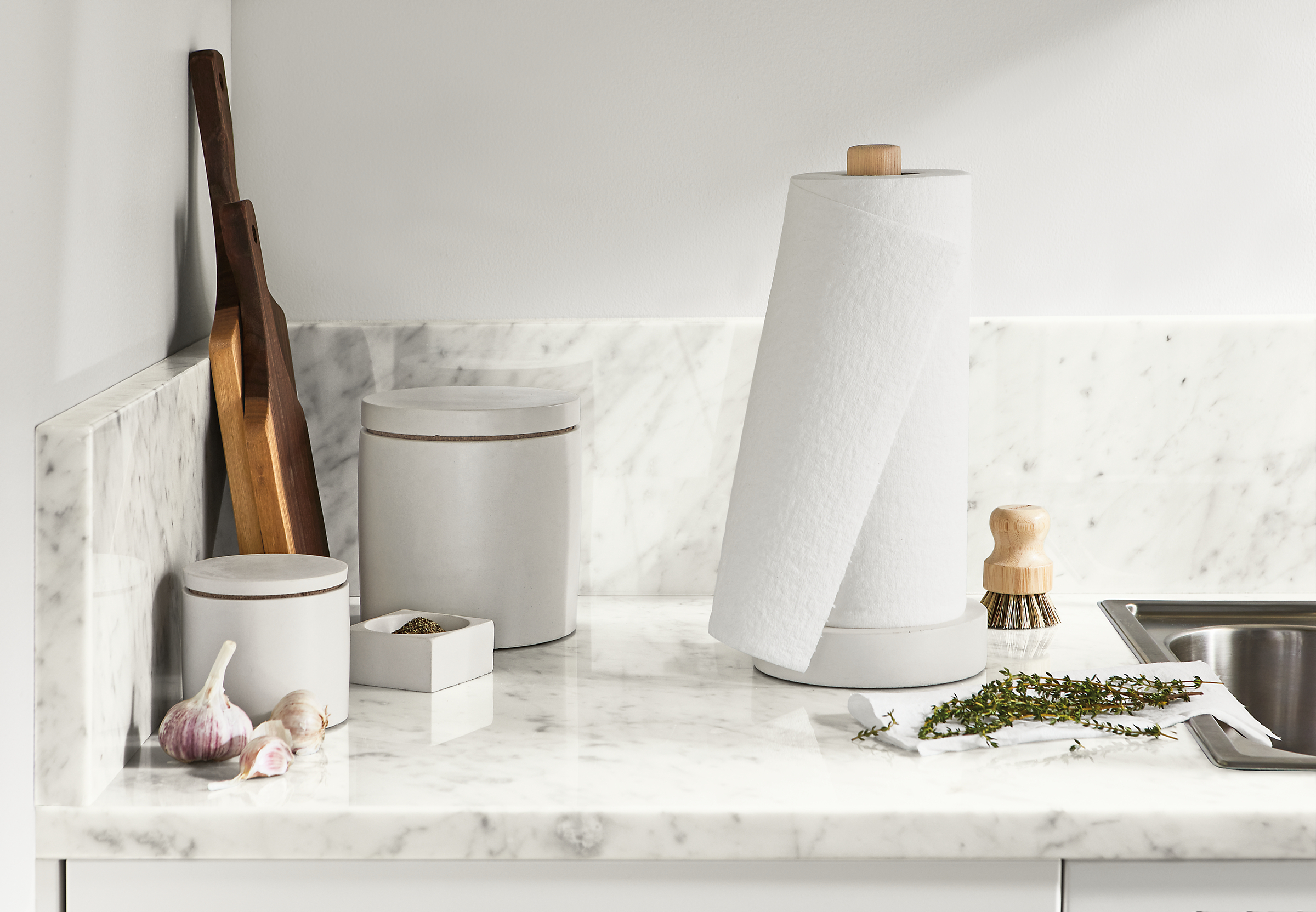 Kitchen setting with saco paper towel holder and canisters in white.
