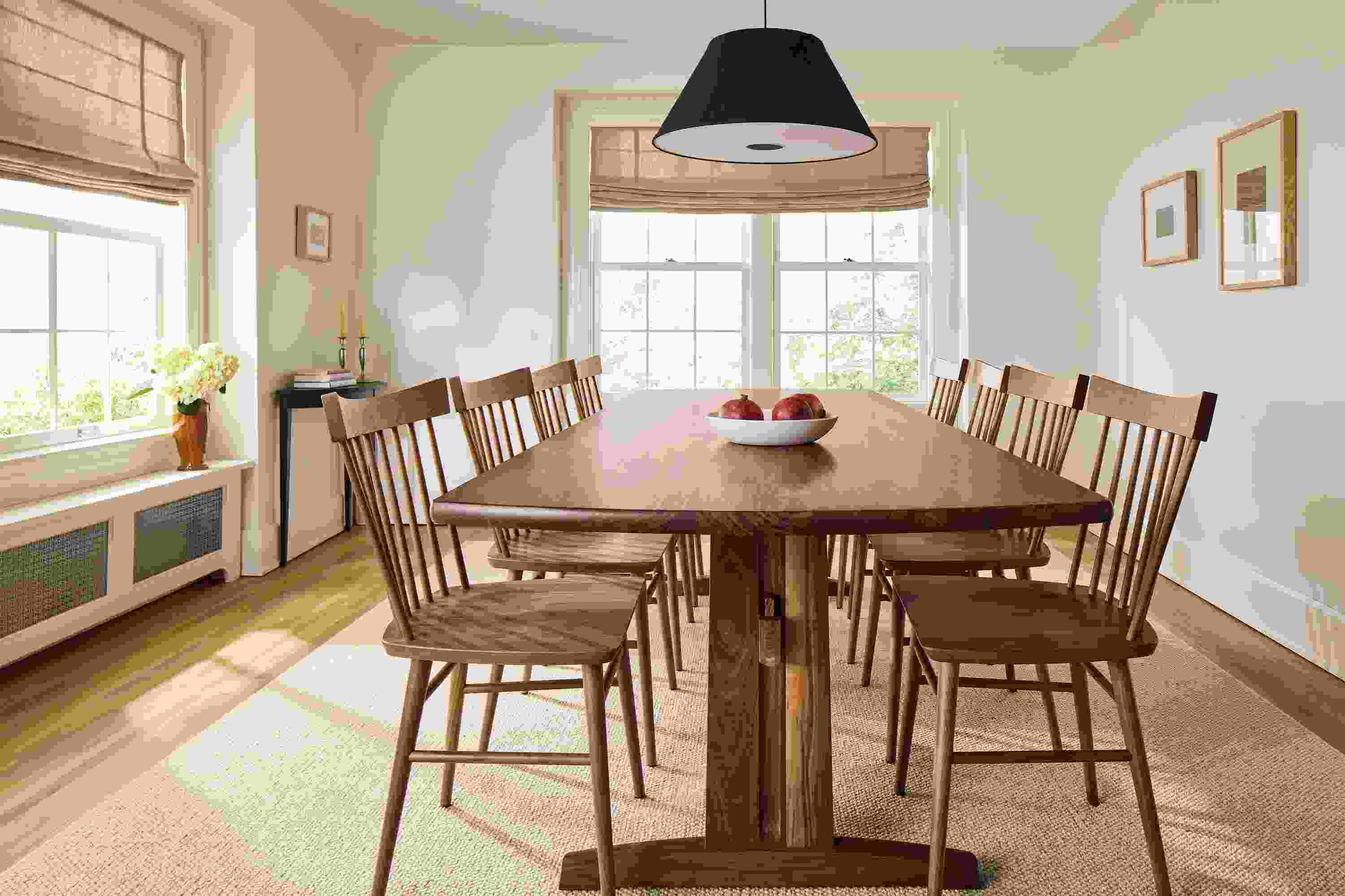 Dining room with detail of Salem Dining table and 8 Thatcher side chairs in walnut and Flannery rug in Oatmeal.