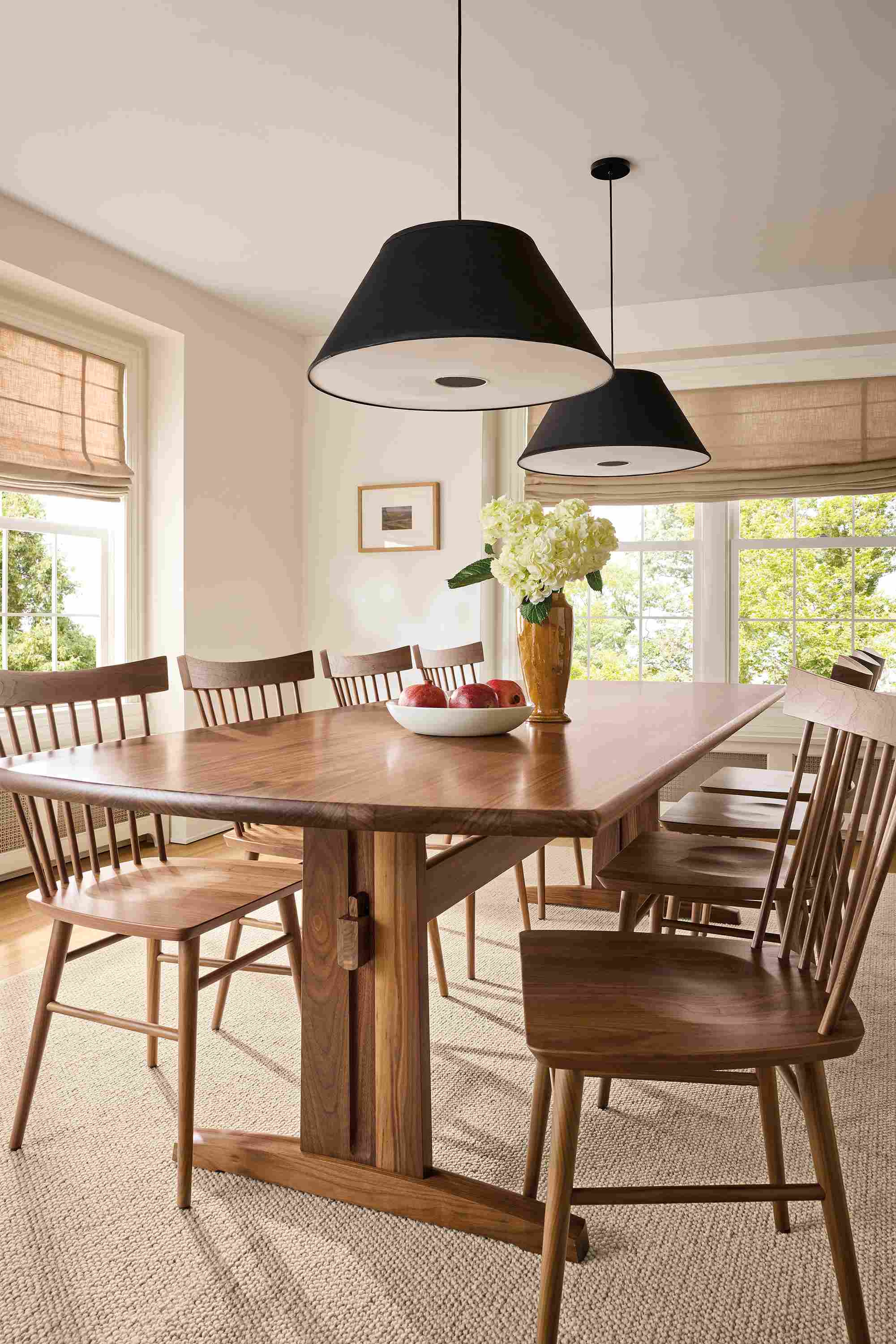 Dining room with Salem 108-wide table in walnut, 8 Thatcher side chairs in walnut and 2 Luisa Pendant lights.