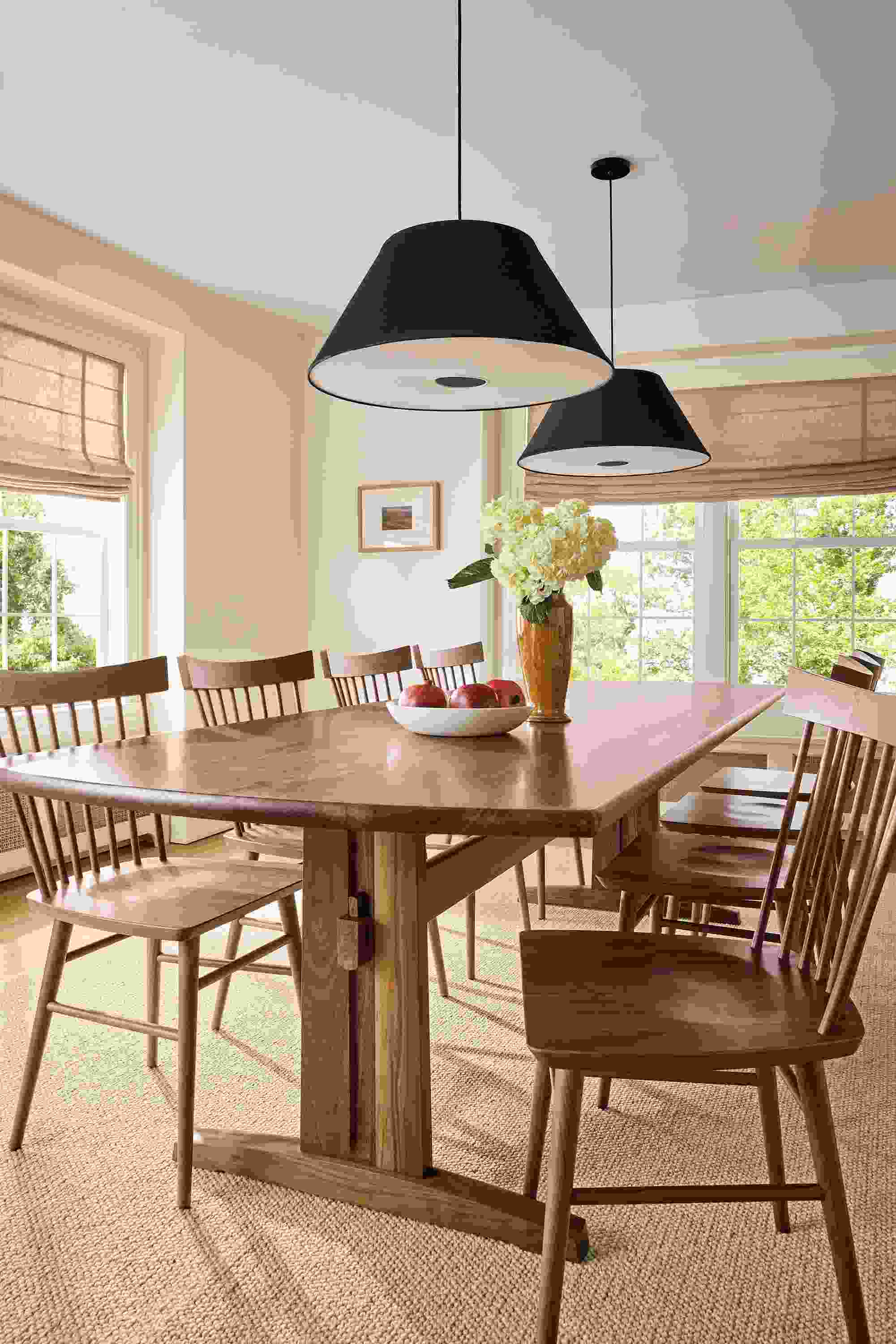 Dining room with Salem 108-wide table in walnut, 8 Thatcher side chairs in walnut and 2 Luisa Pendant lights.