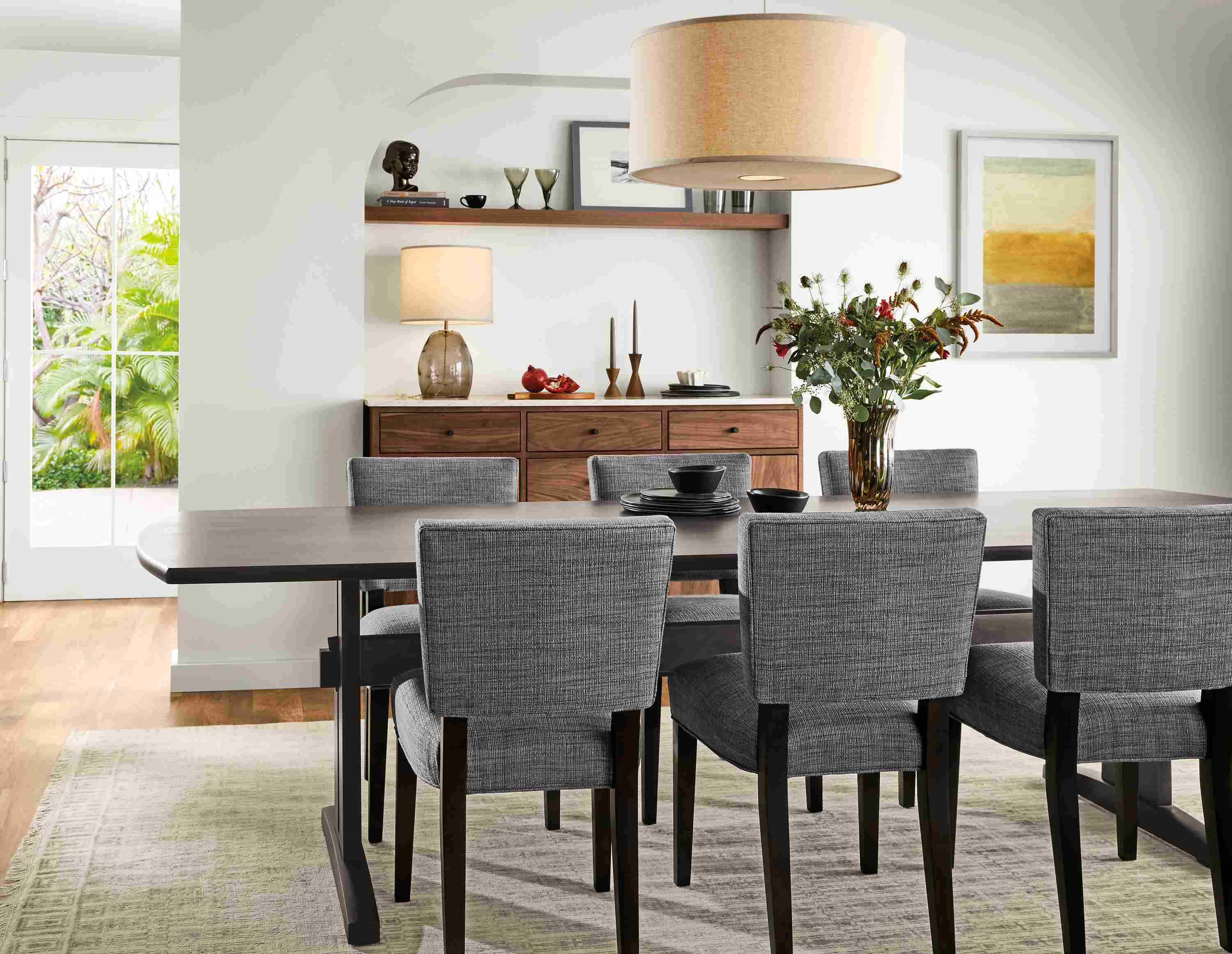 Dining room with Salem 108-wide table in charcoal, 6 Georgia side chairs in Alston Ink and charcoal and Tulum rug in taupe.