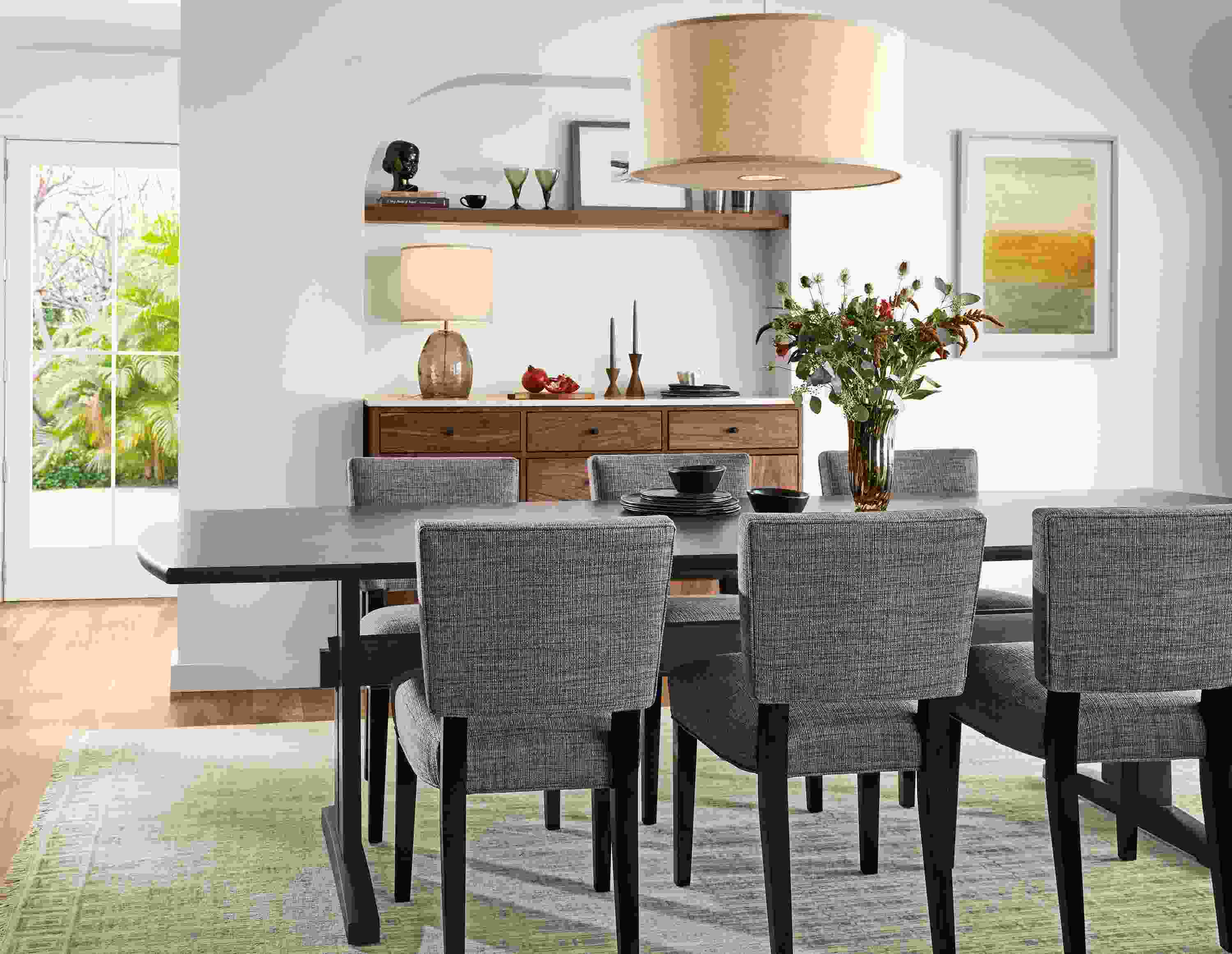 Dining room with Salem 108-wide table in charcoal, 6 Georgia side chairs in Alston Ink and charcoal and Tulum rug in taupe.